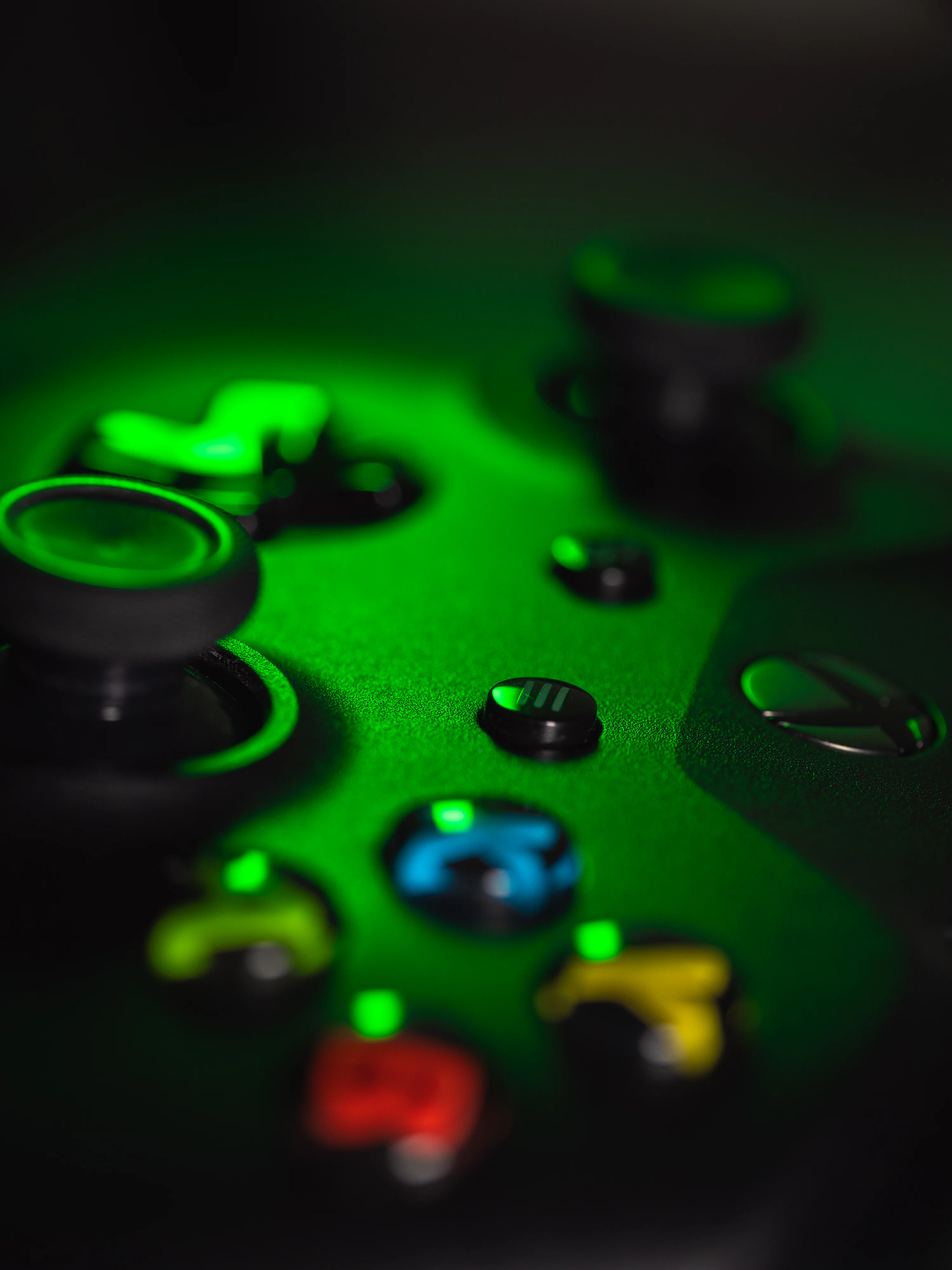 Close Up View Of A Gaming Controller, Lit In Green. Photo