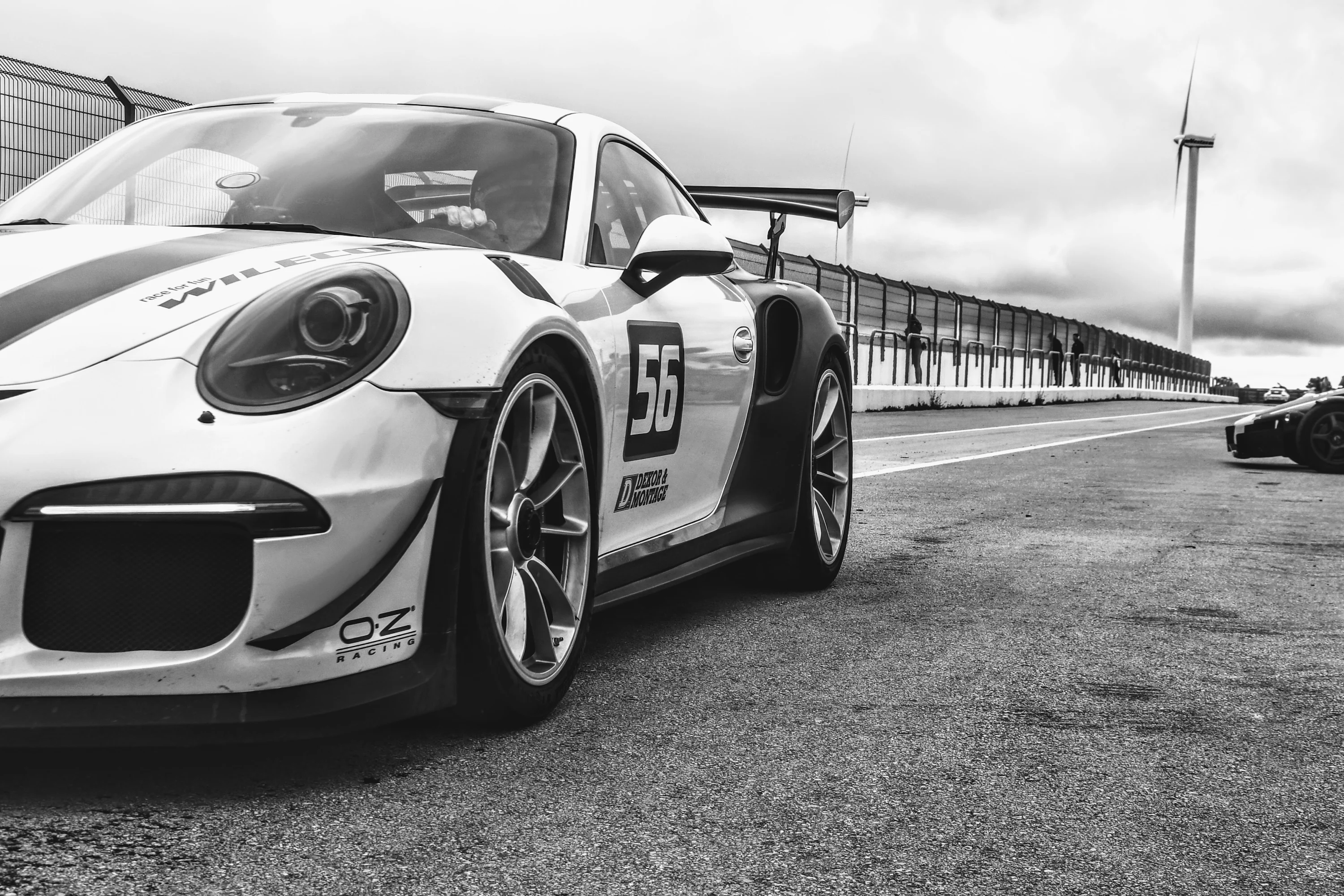 A black and white photo of a race car photo