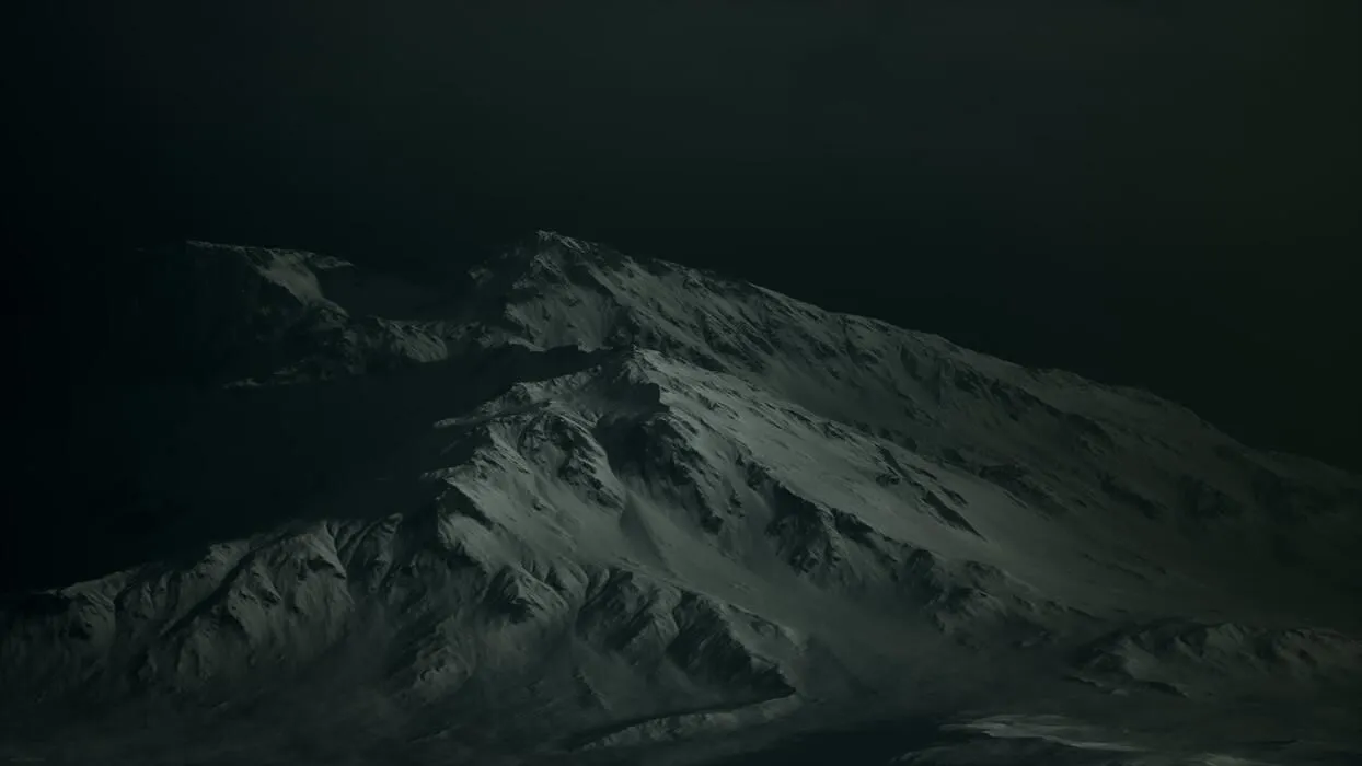 Dramatic dark rocky mountain with patches of snow in storm