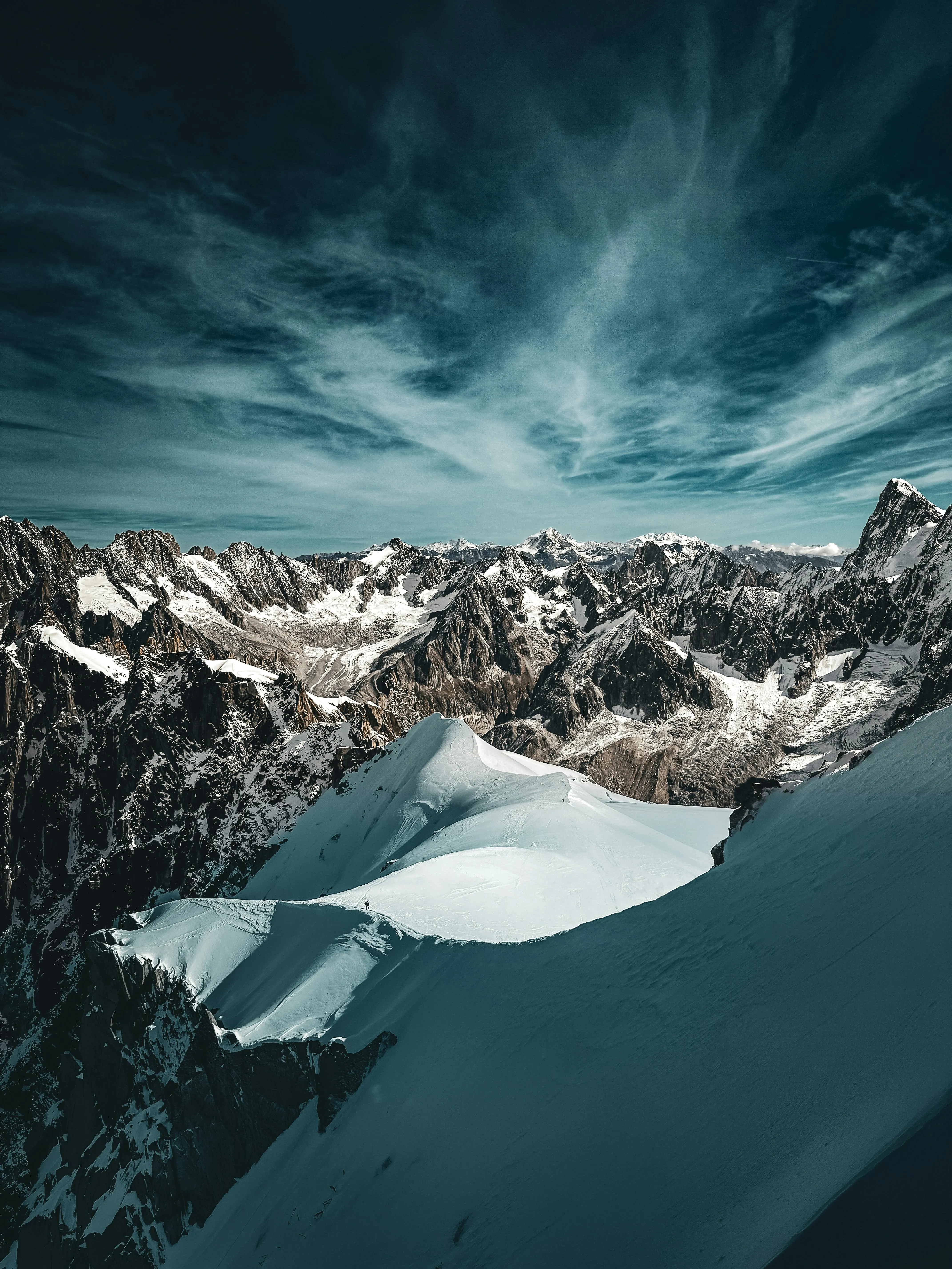 An Aerial Shot of a Snowy Lakeshore with the Mountain Range Background · Free