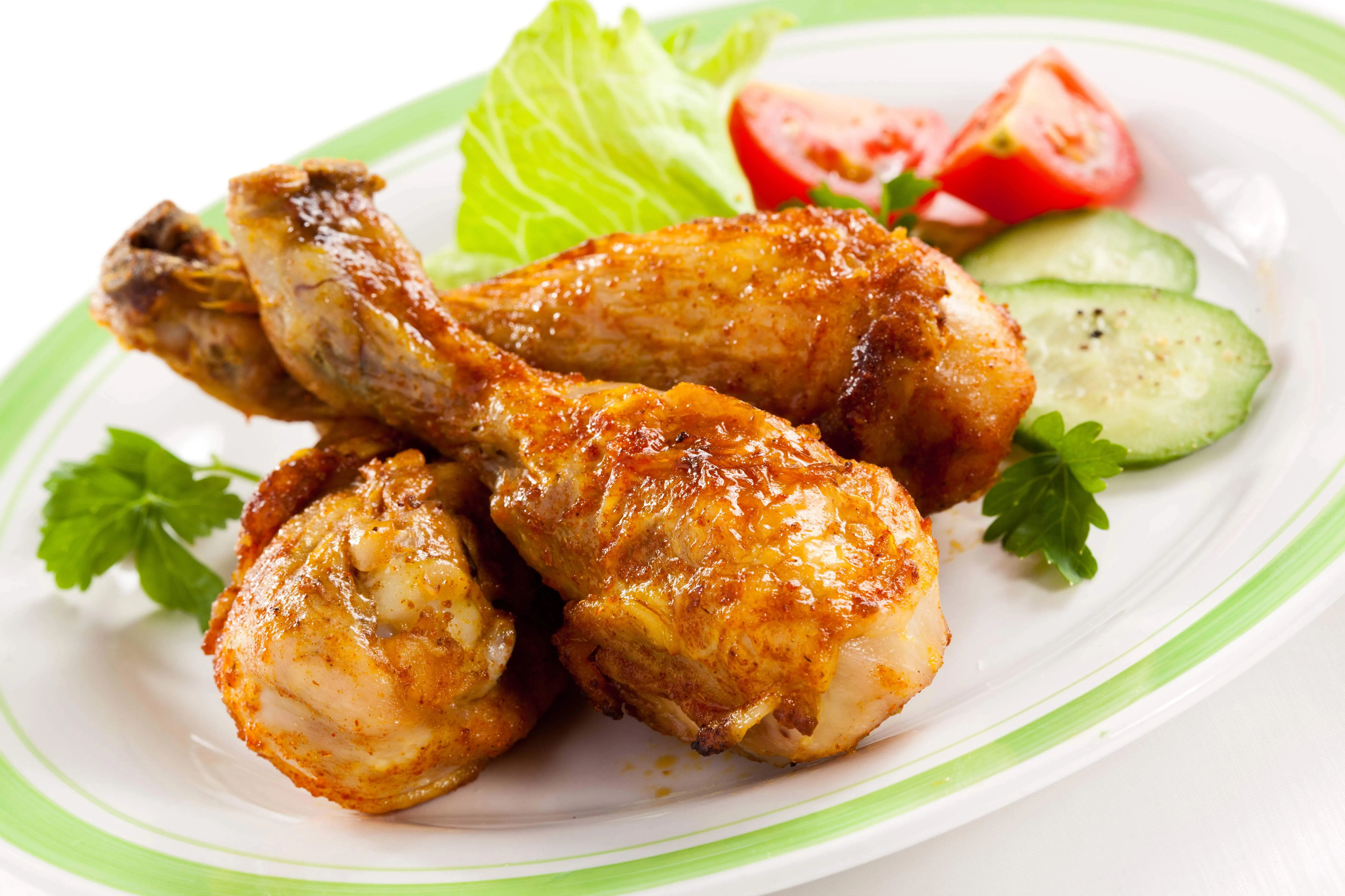 Fried chicken legs on a plate with vegetables Desktop wallpaper 1024x600