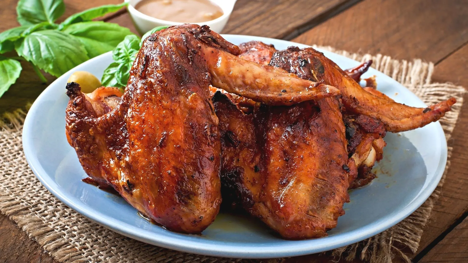 Fried chicken wings on a table with sauce and basil Desktop wallpaper 1920x1080