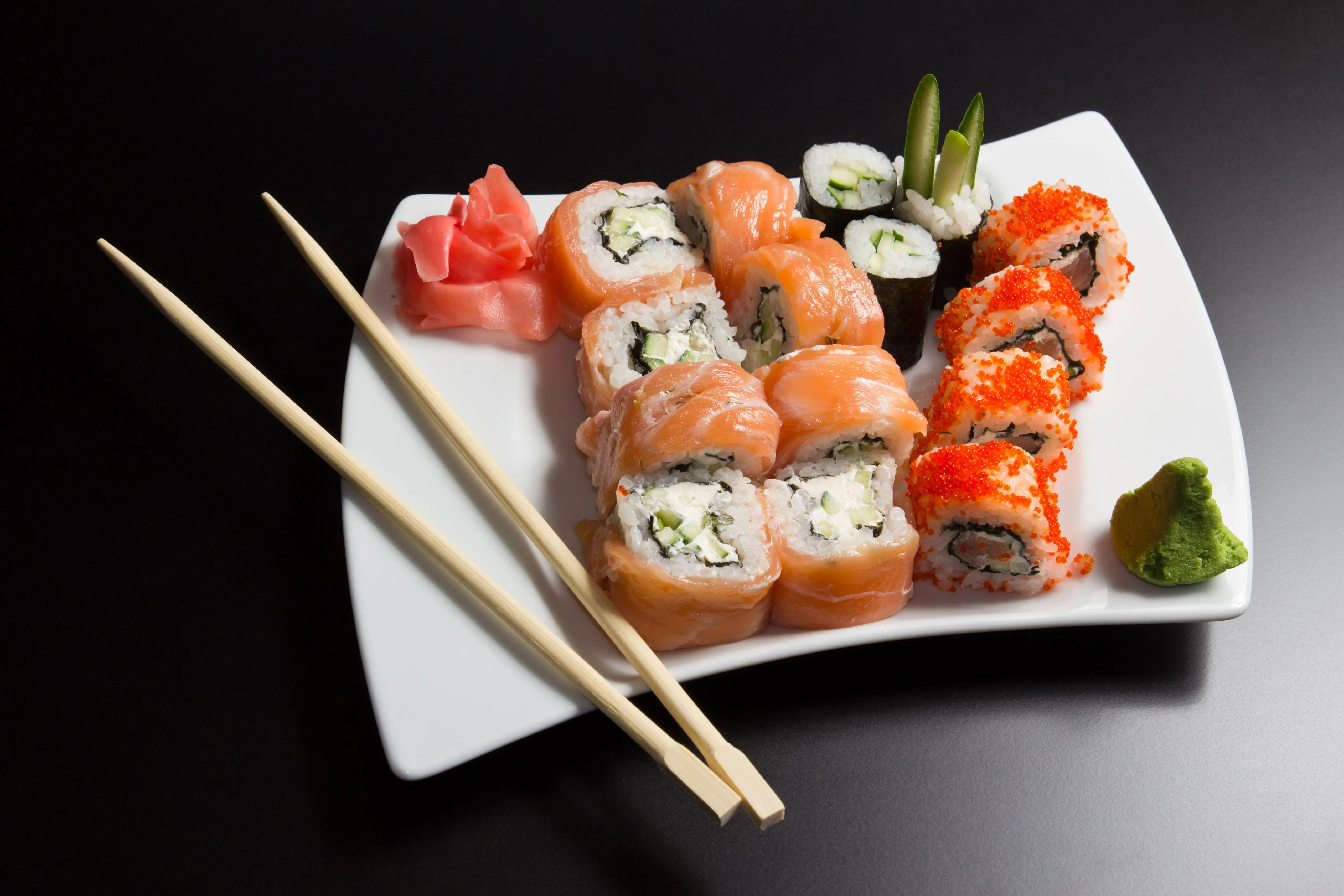 Delicious japanese sushi on a white plate with chopsticks Desktop wallpaper 1024x1024
