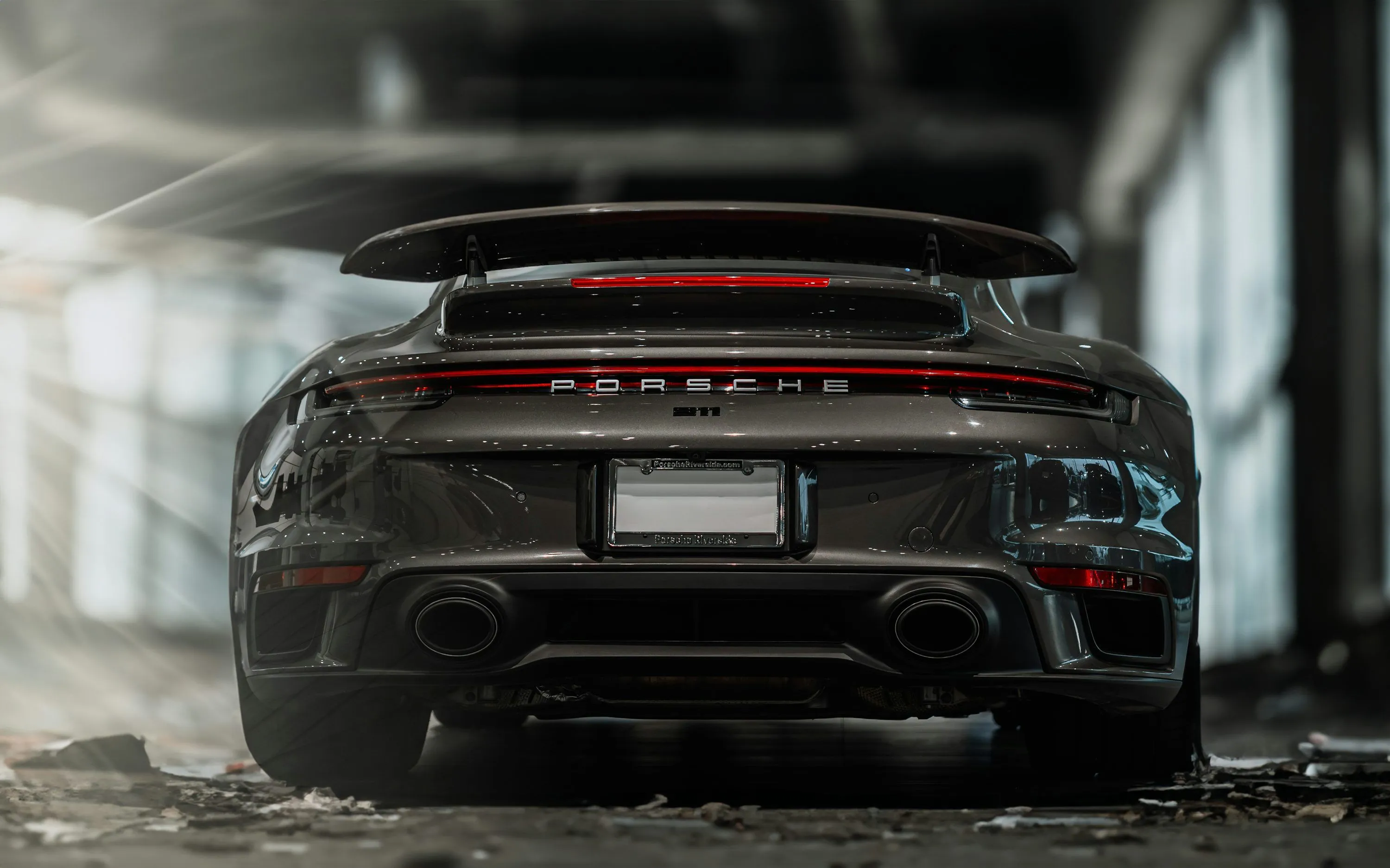 The rear end of a grey porsche sports car photo