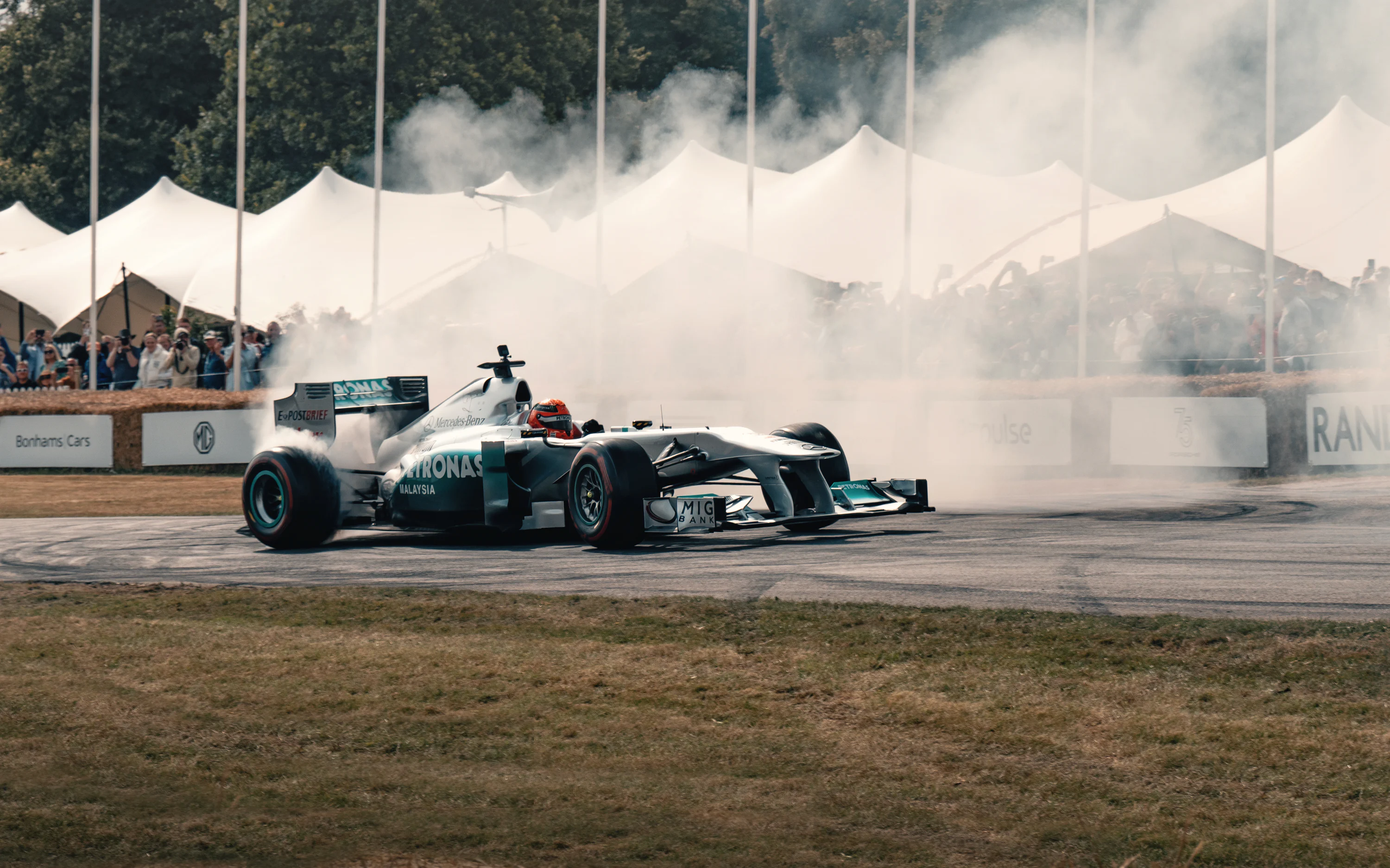 A man driving a race car on top of a race track photo