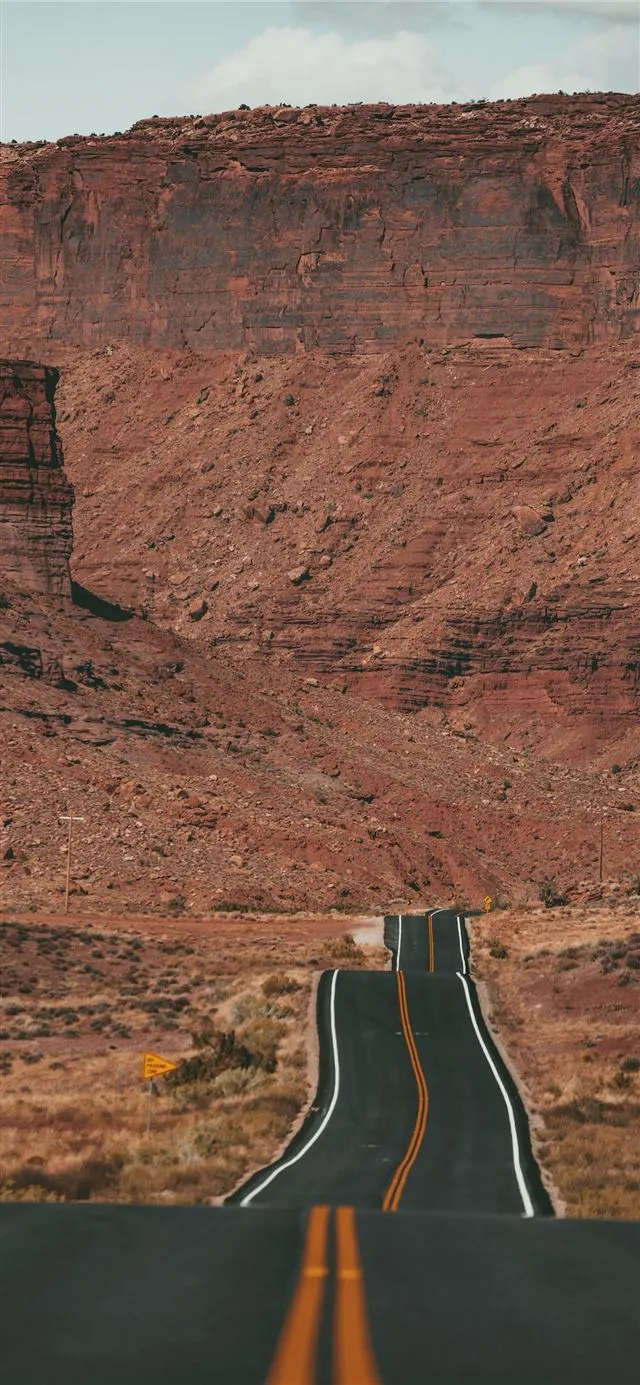 white car on road near brown rock formation during. iPhone 11 Wallpaper Free Download