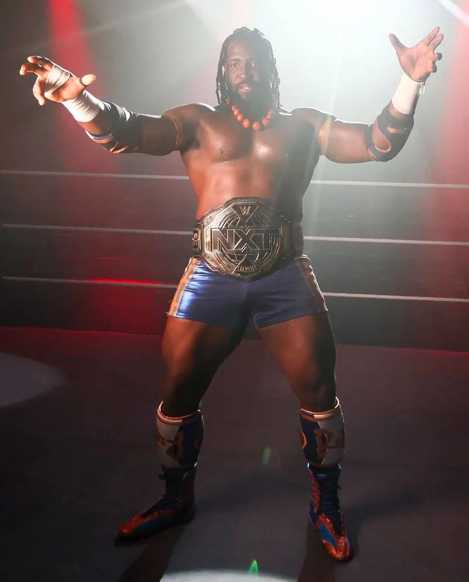 Oba Femi posing with the NXT world title