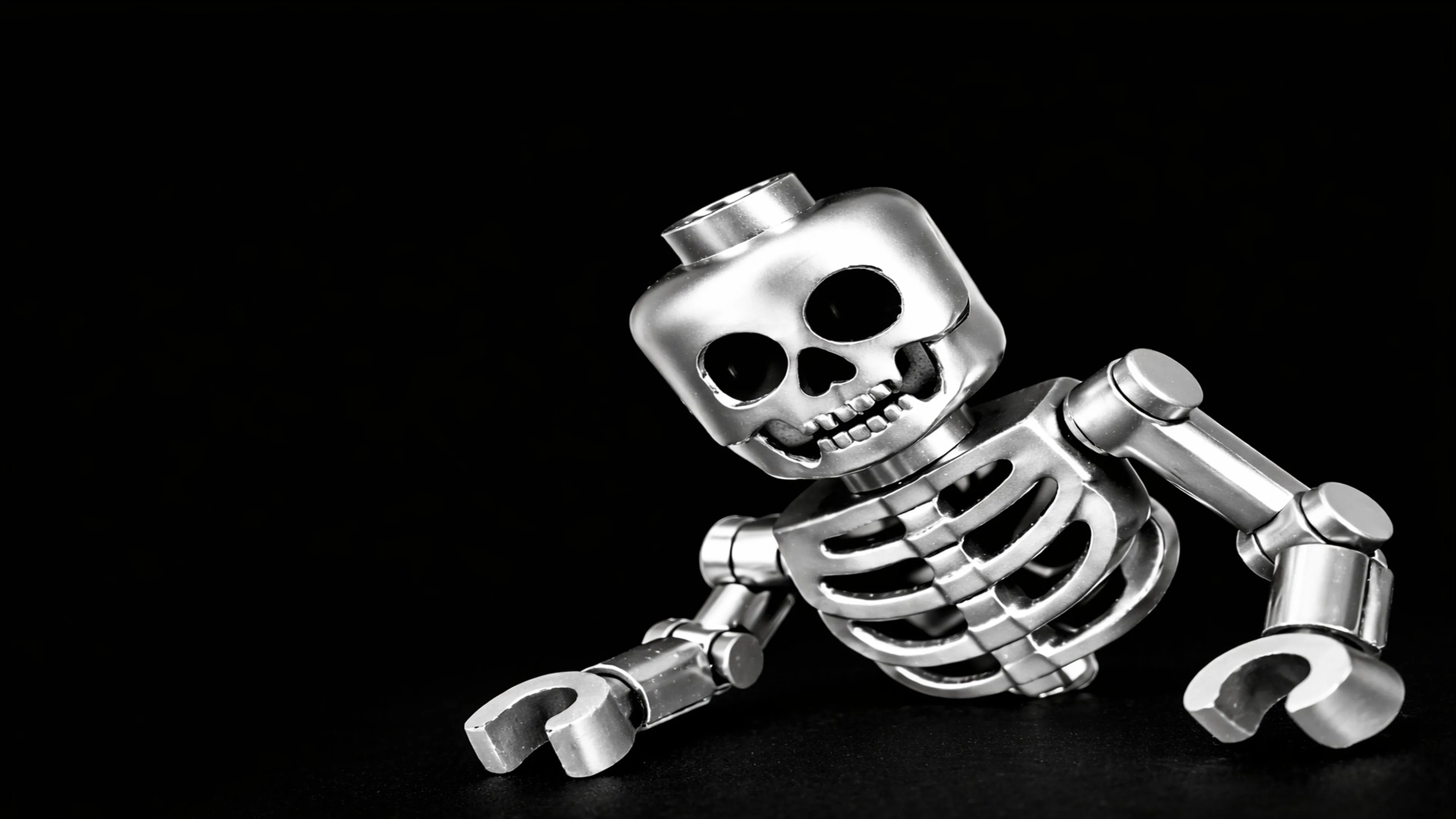 Shiny Lego Skeleton Strikes a Cheeky Pose on Deep Black
