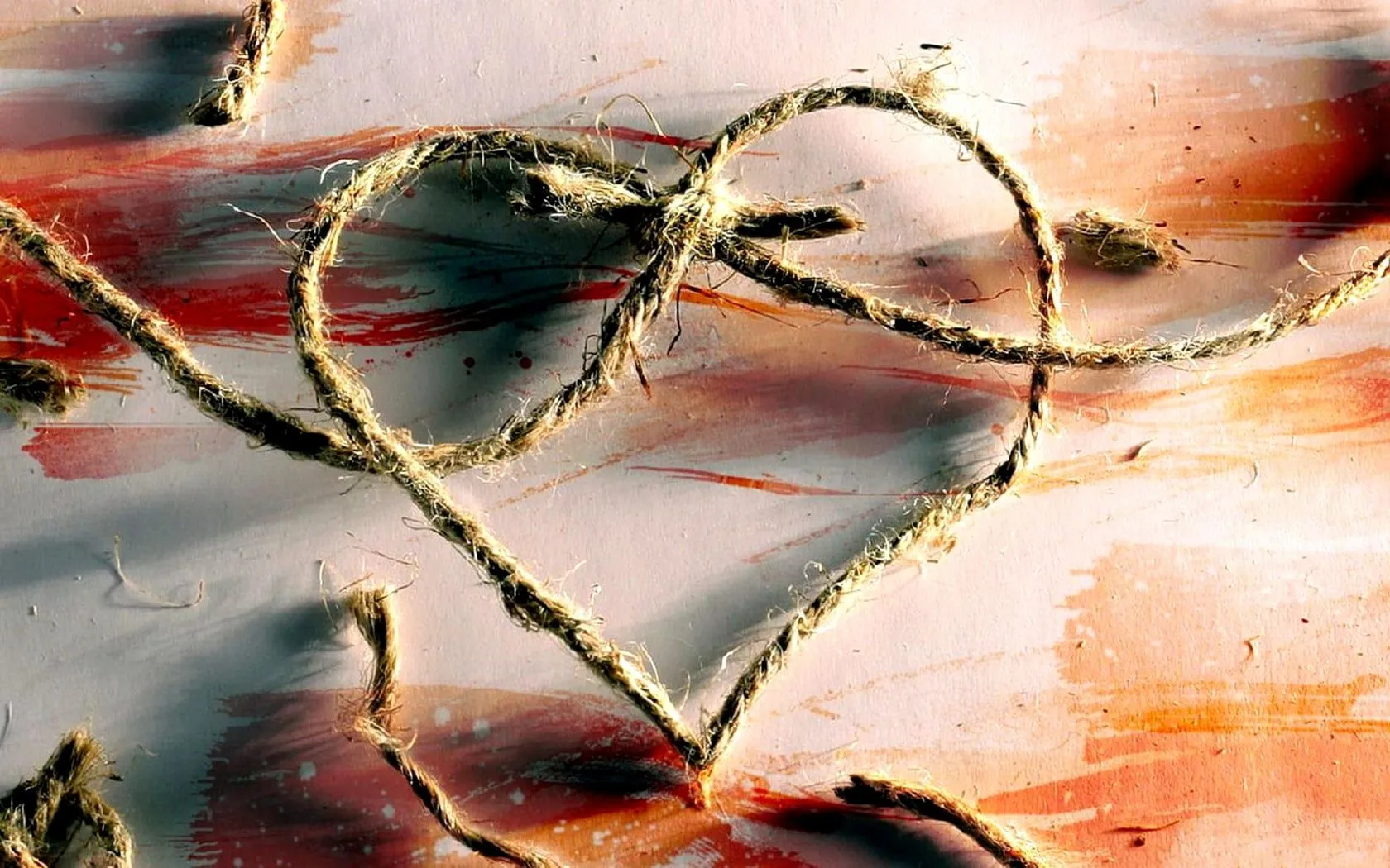 Brown rope heart shape on white and maroon wooden surface HD wallpaper