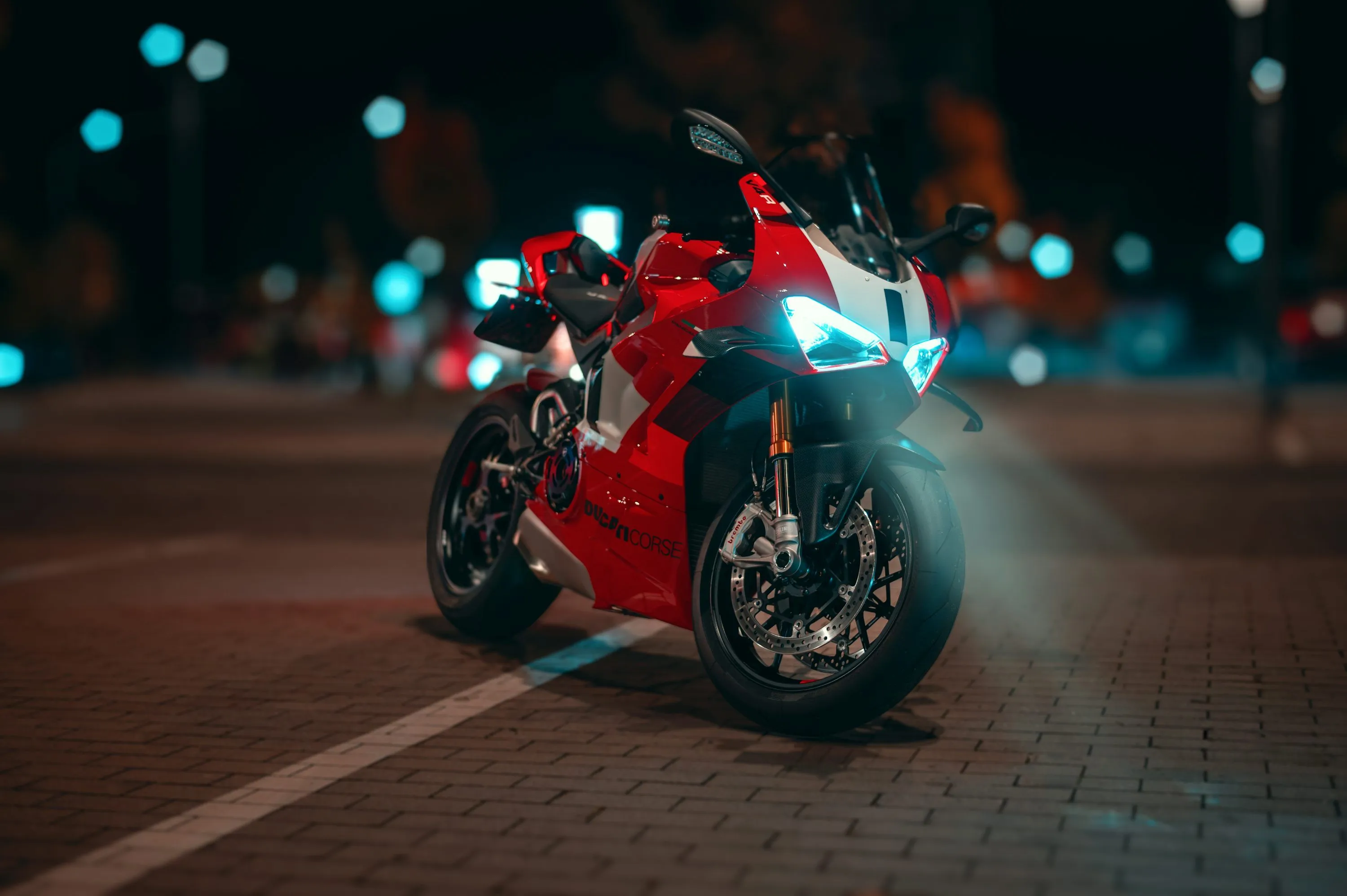 A red and white motorcycle parked on the side of a road photo