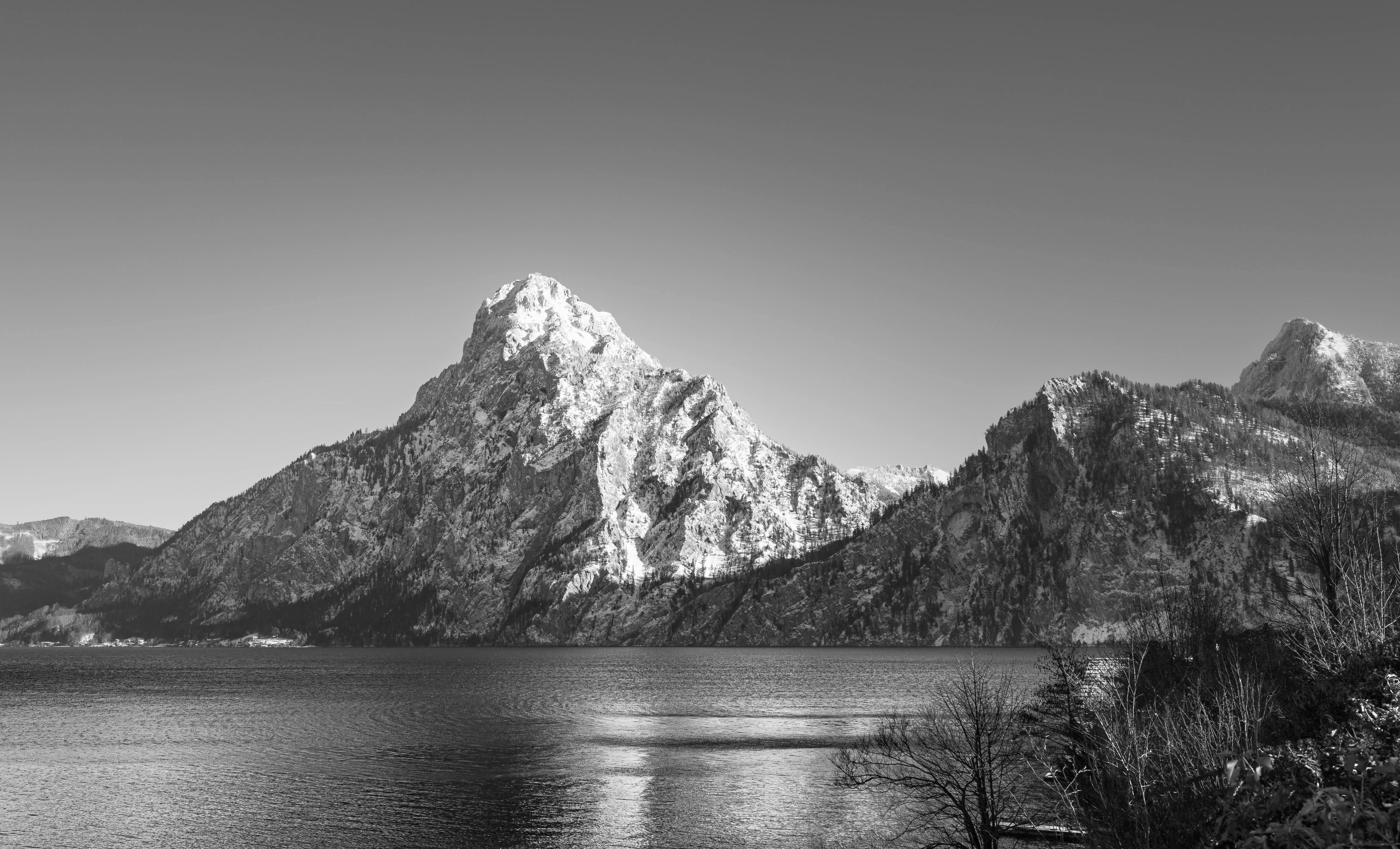 Clear Sky over Lake and Rocky Mountain in Black and White · Free