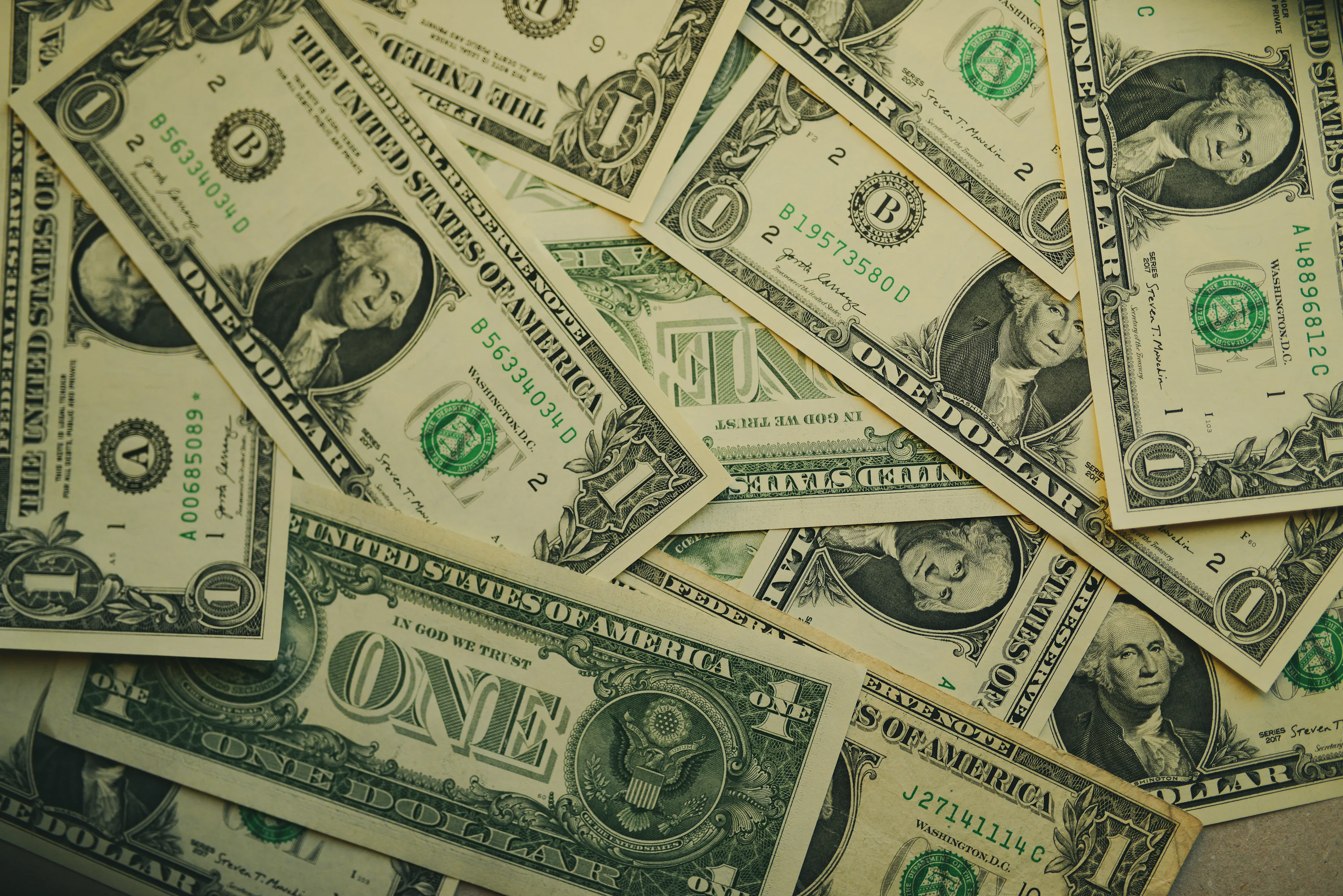 A pile of twenty dollar bills laying on top of each other photo