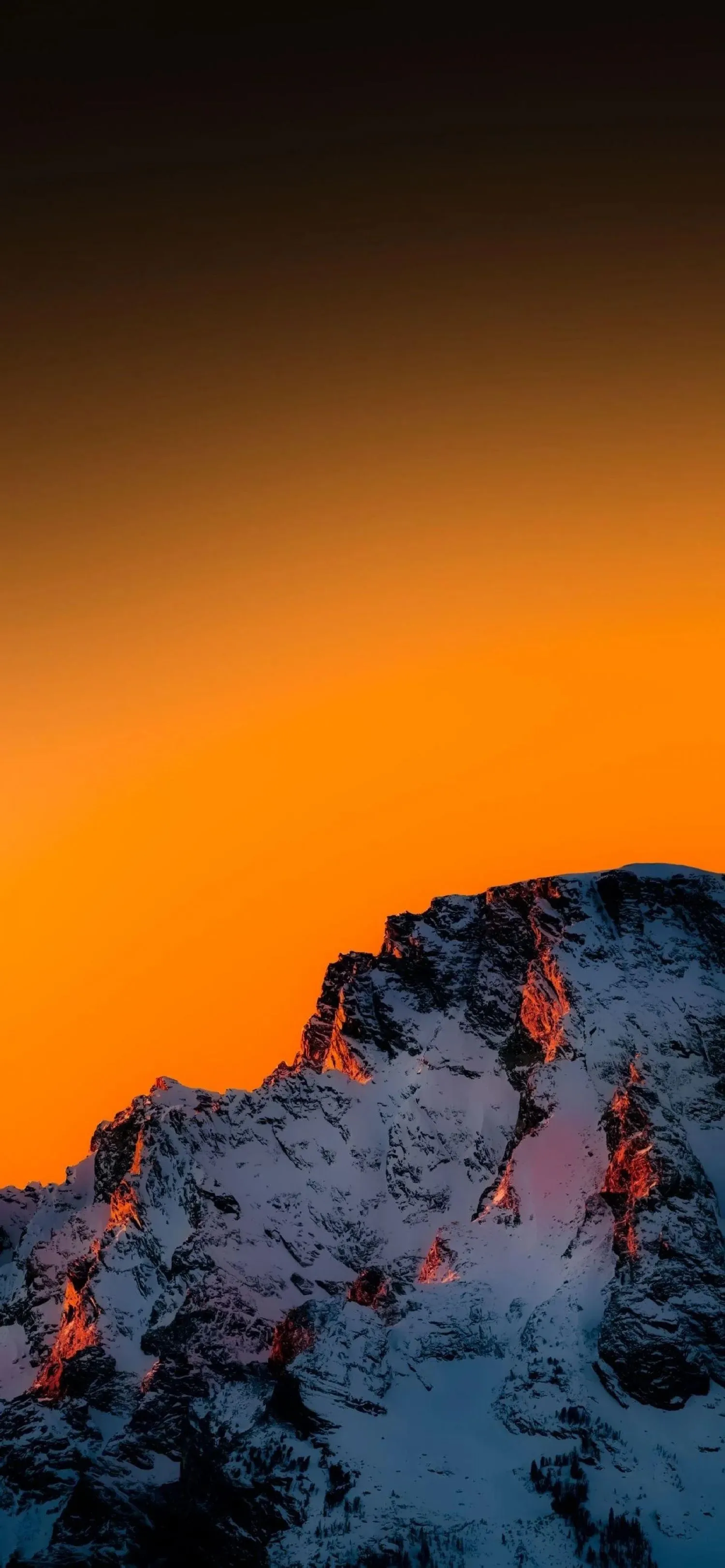 Orange Sunset Over Snow Covered Mountain