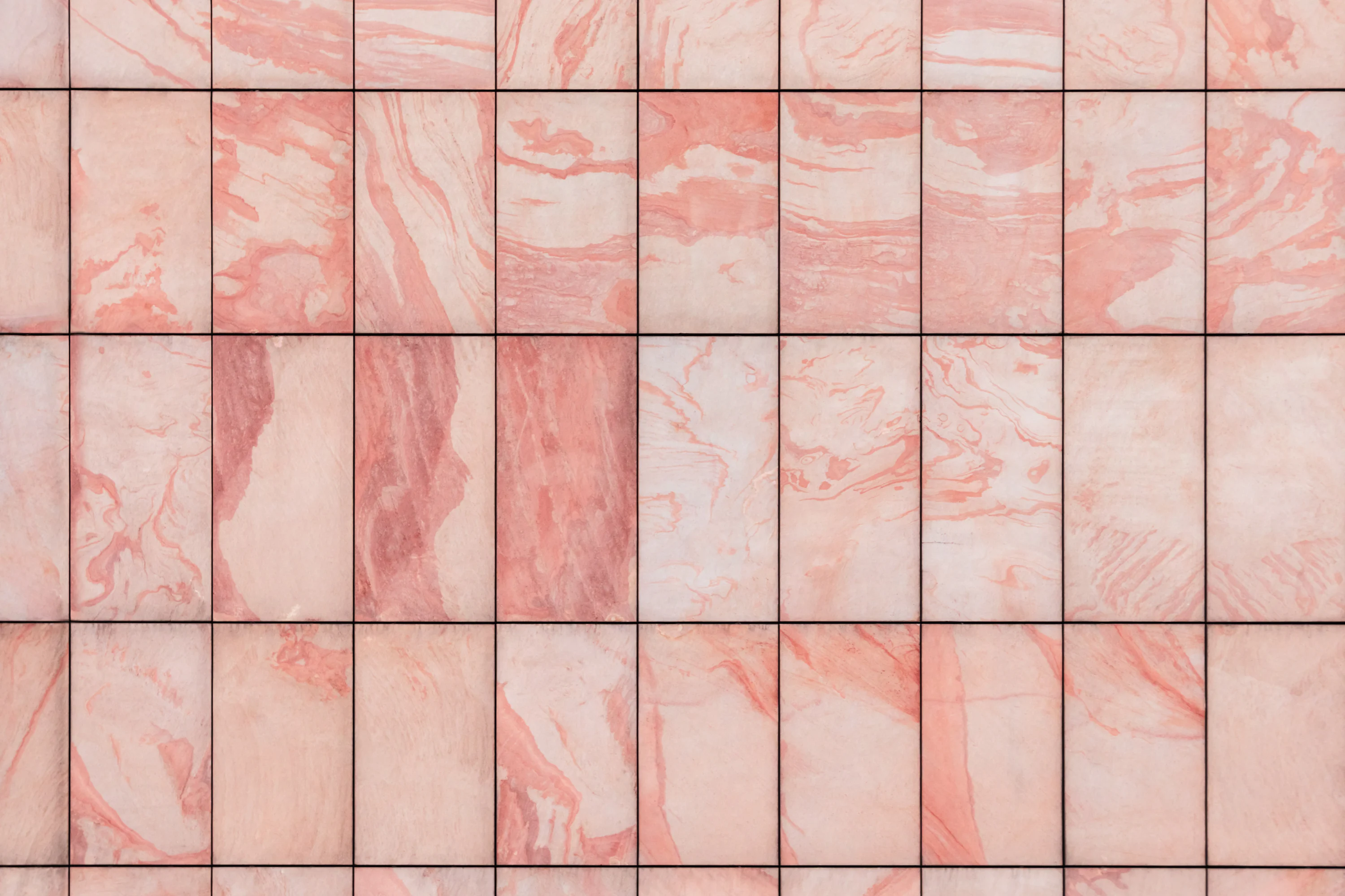A close up of a pink marble tile wall photo