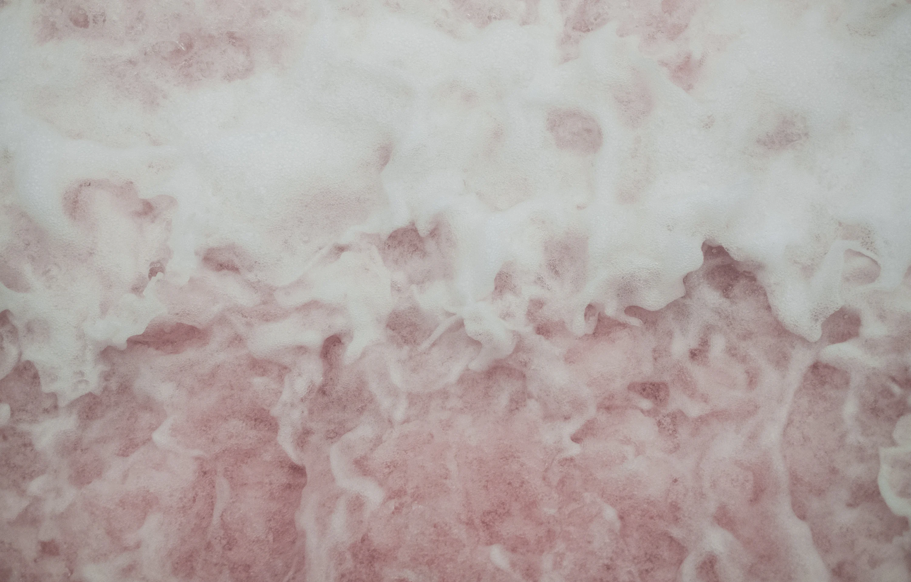 A close up of a pink and white wall photo