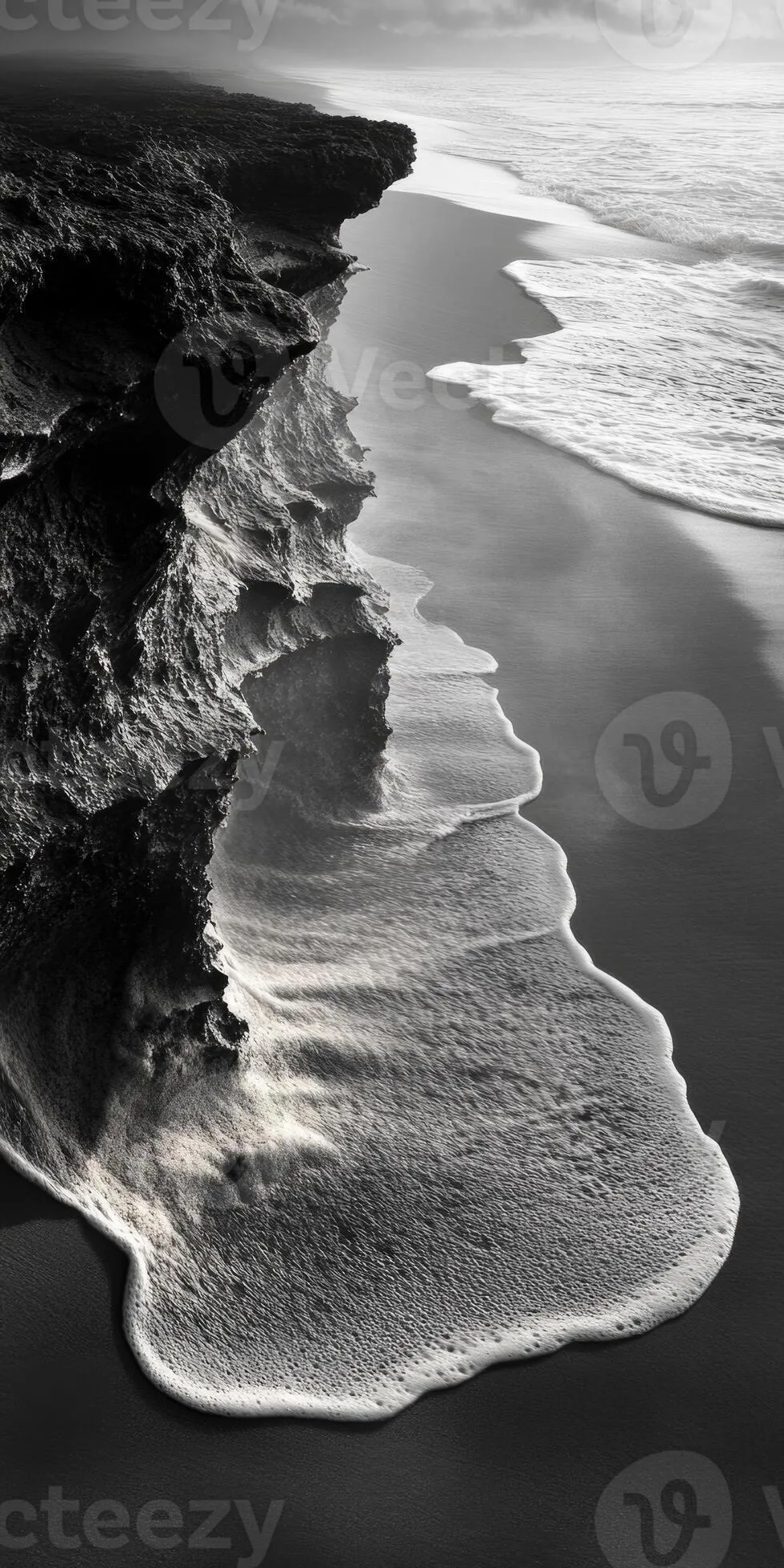 Serene black and white coastal landscape with waves gently lapping at rocky shore mobile phone wallpaper