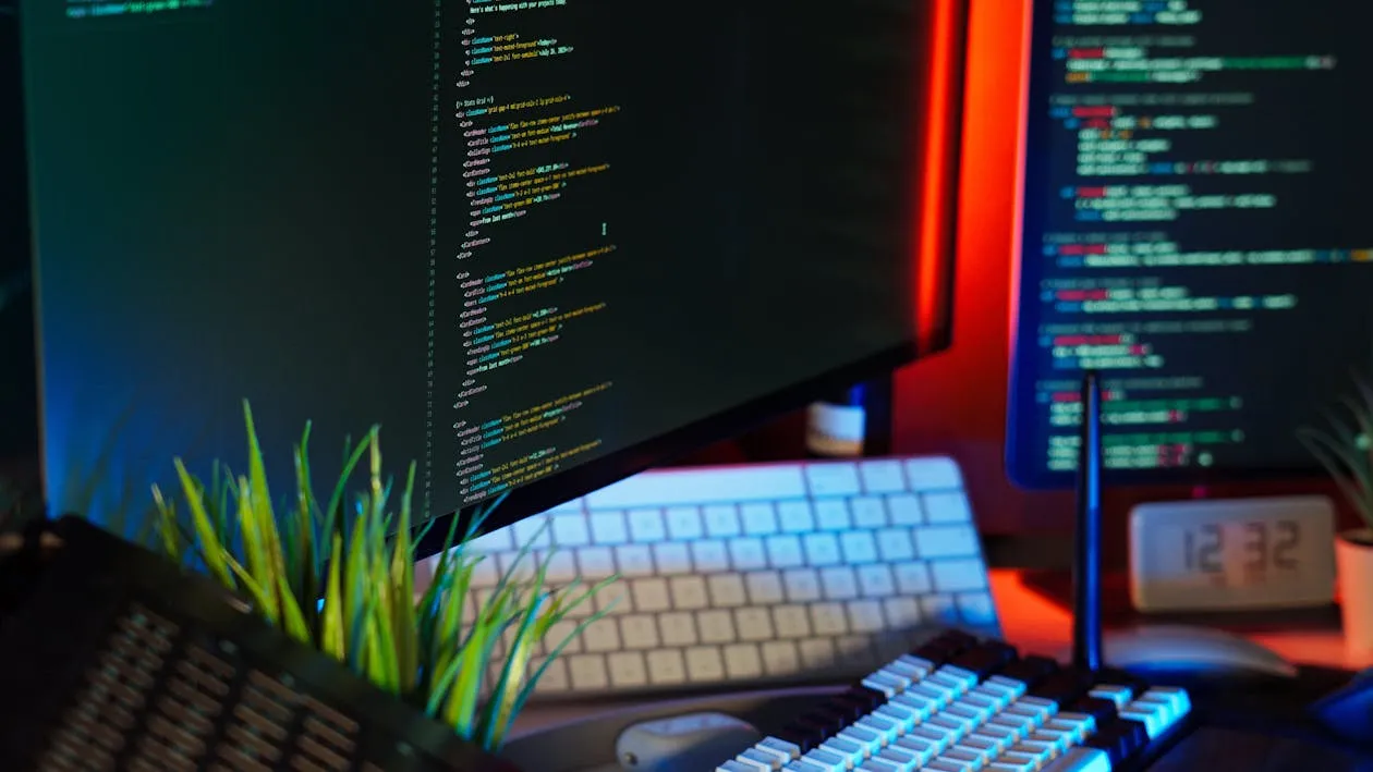 Modern Workspace with Coding Screens and Keyboard · Free