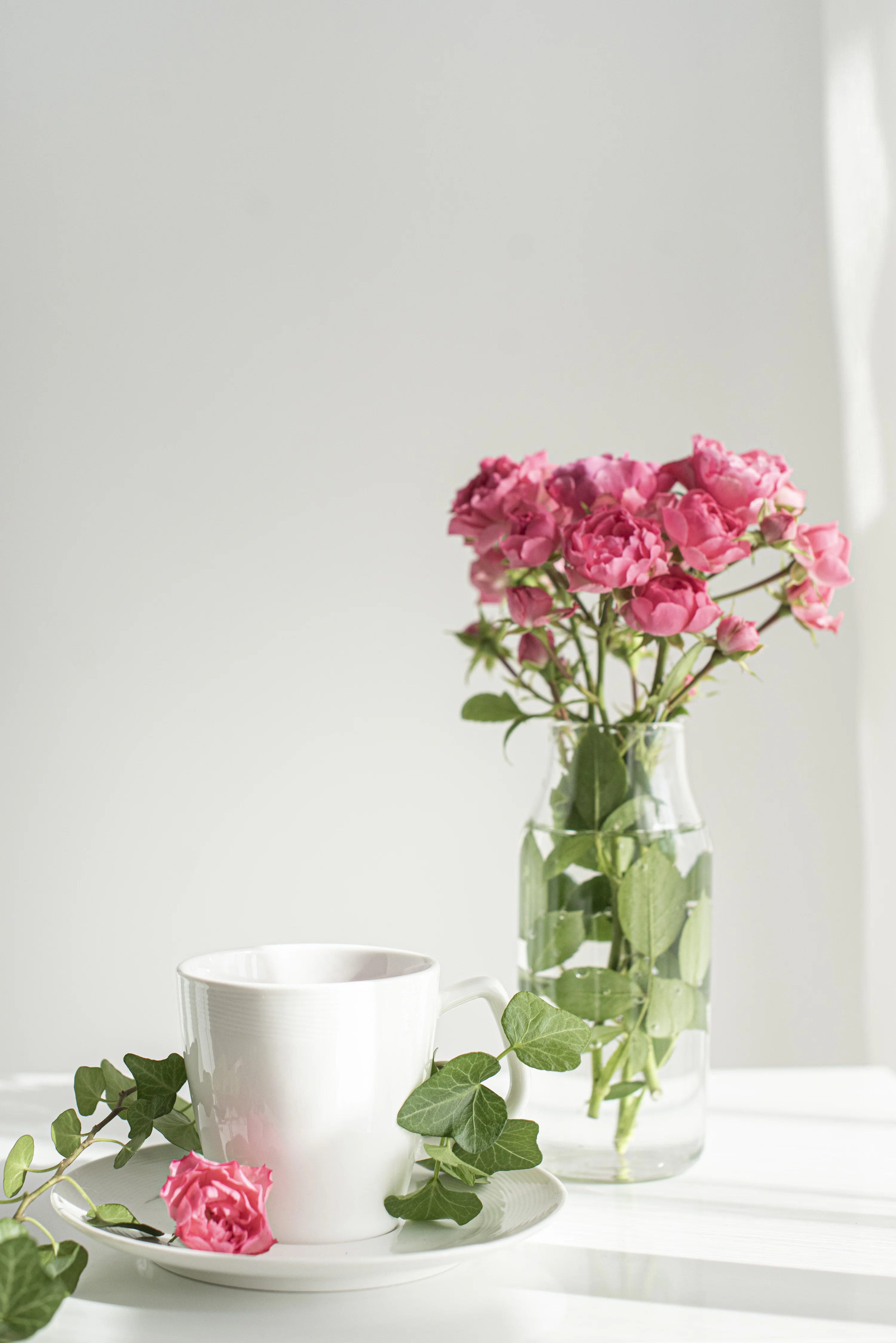 Pink flowers in clear glass vase photo