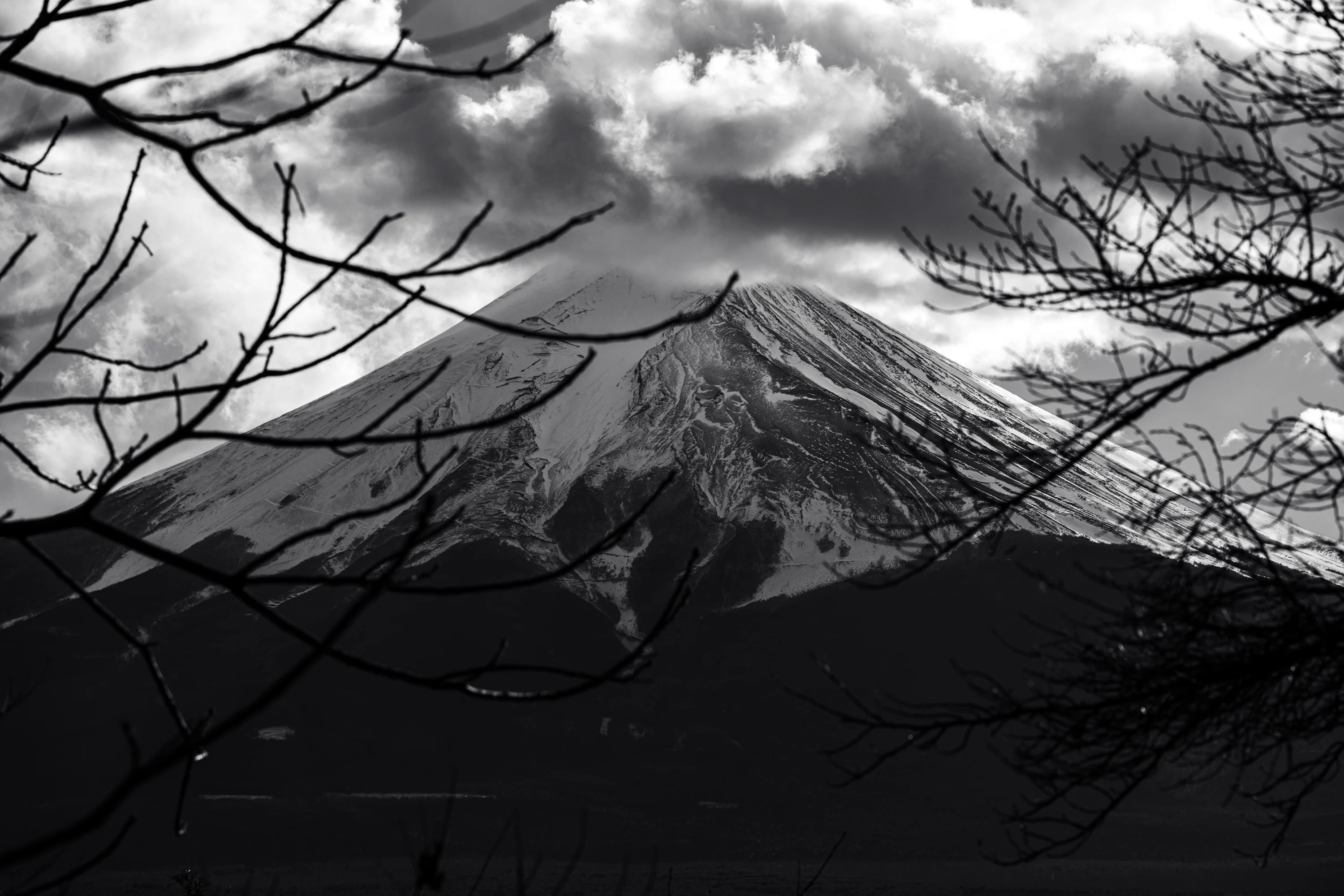A black and white photo of a snow covered mountain photo