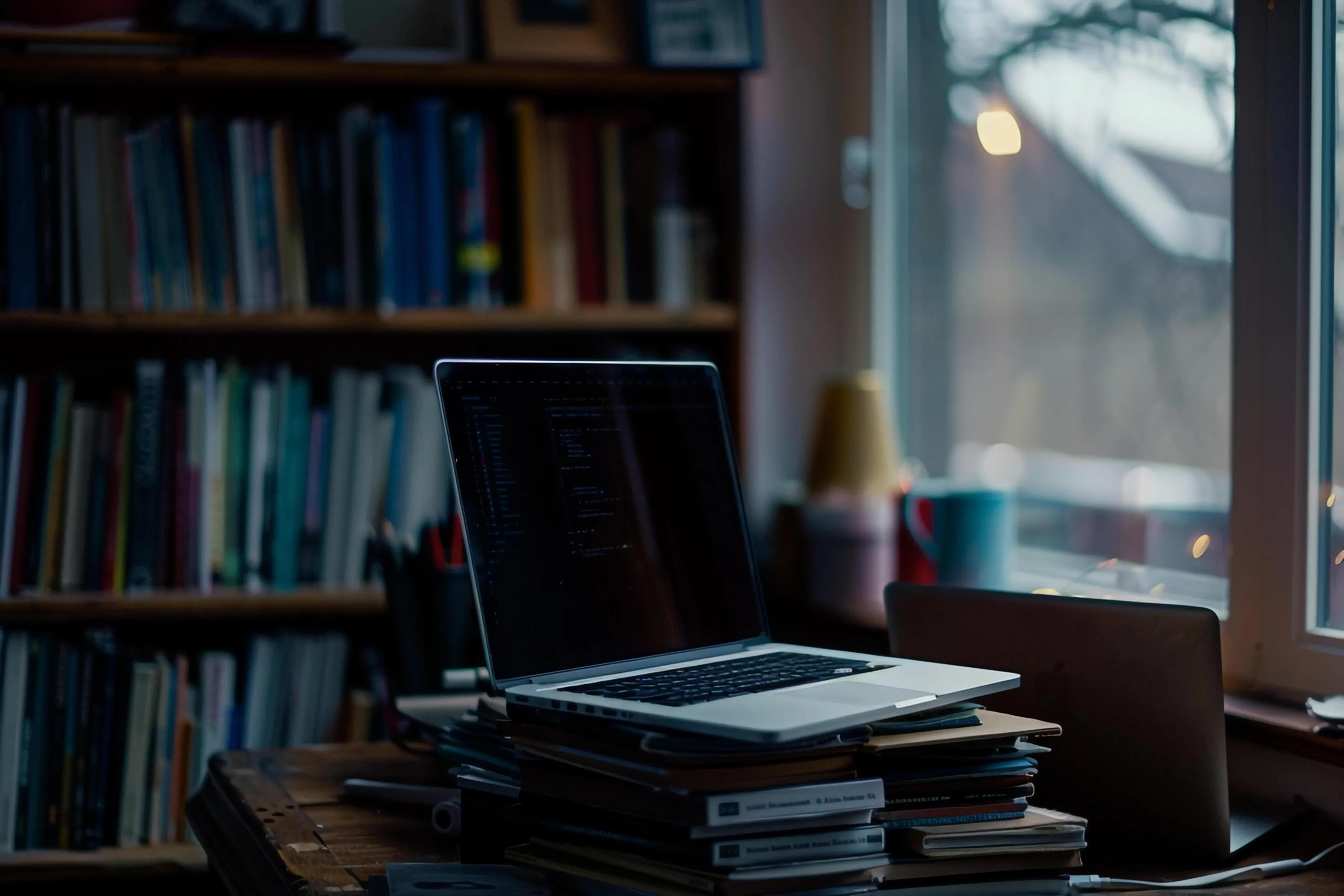 Programmers Desk Setup with Laptop Coding Books and Workspace Background