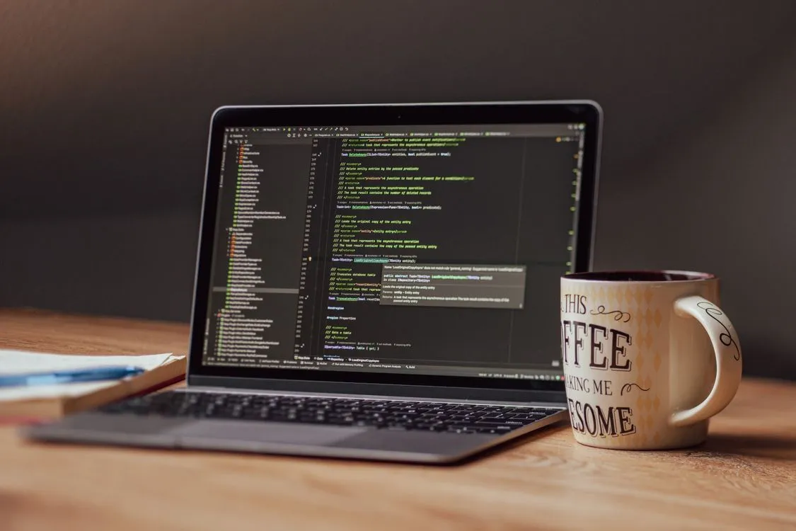 Modern Workspace with Coding Laptop and Coffee · Free