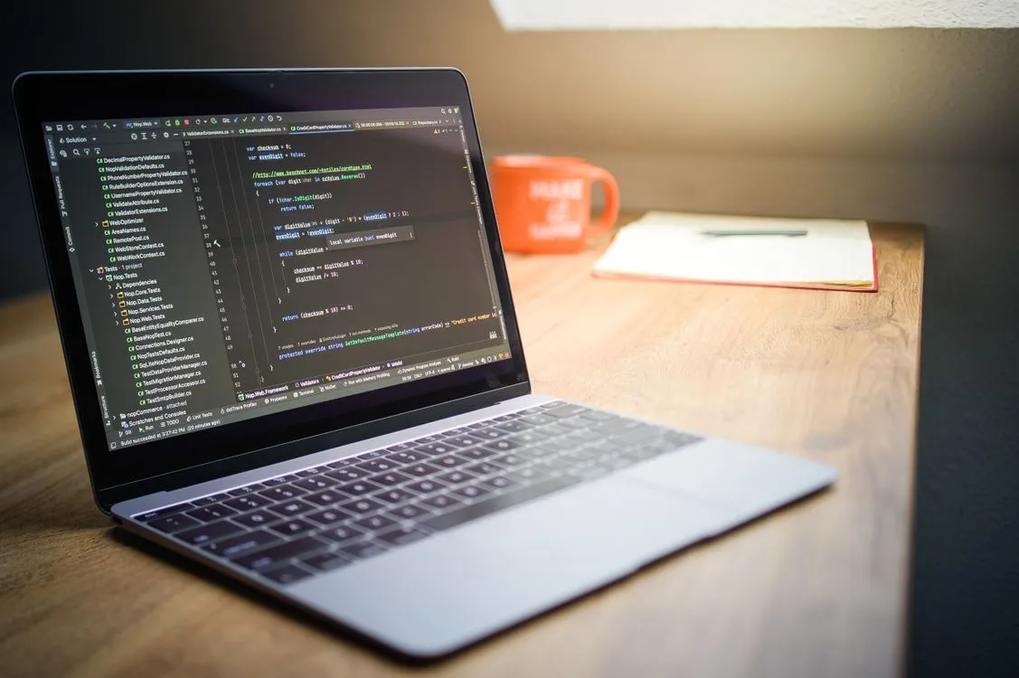 Modern Workspace with Laptop and Code Display · Free