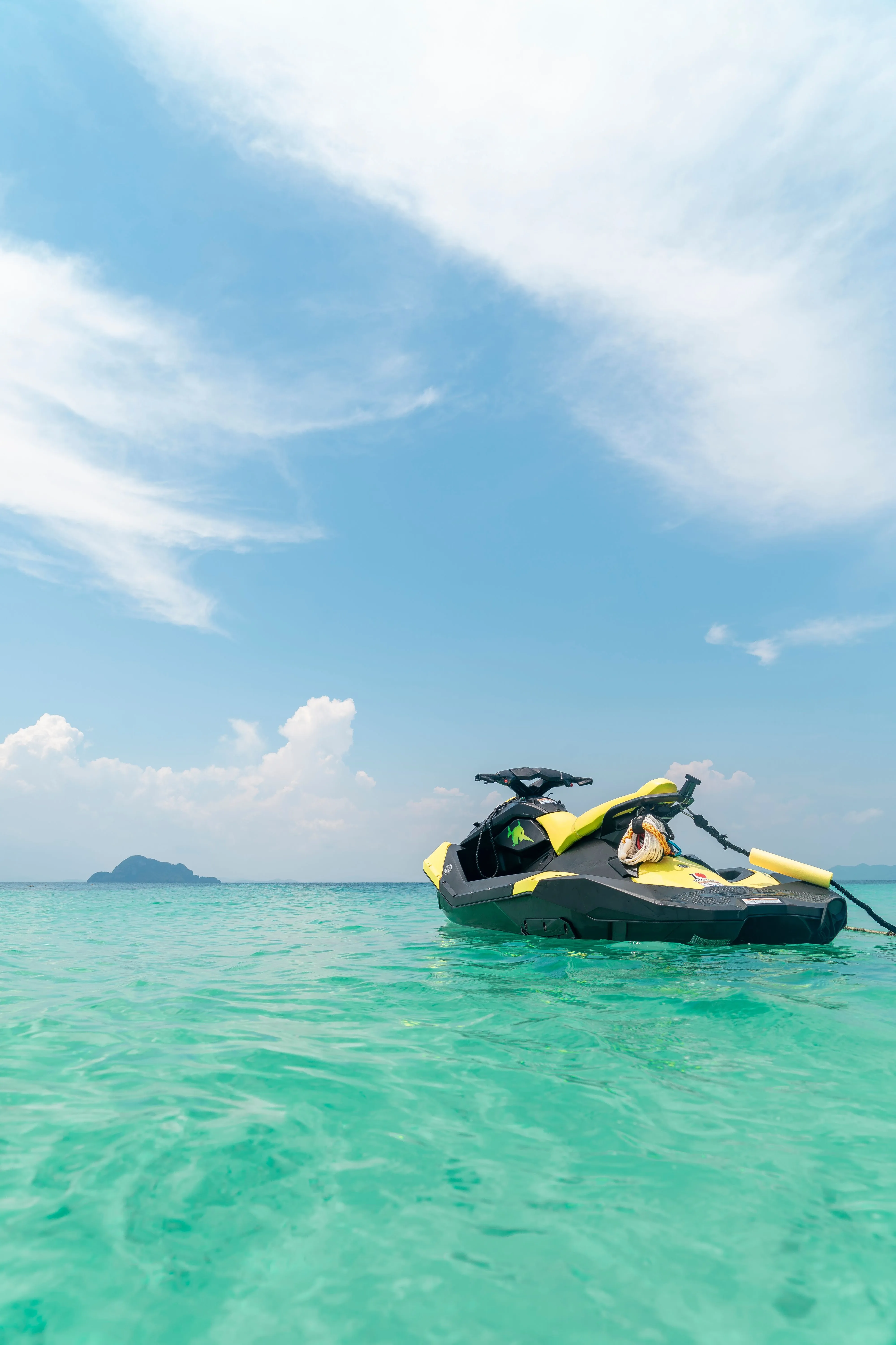 Empty Yellow and Black Jet Ski in Teal Sea Water · Free