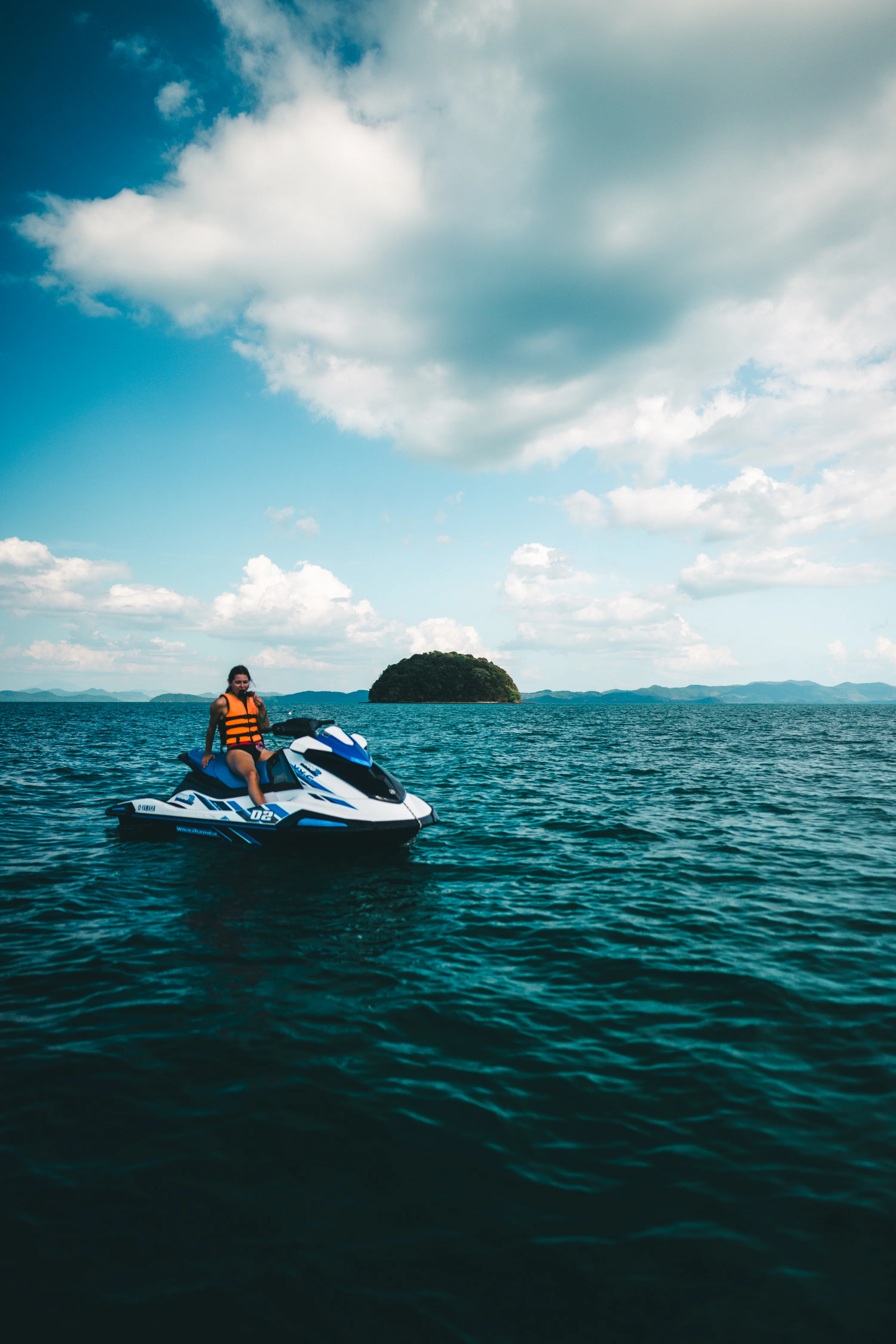 Woman rides jet ski on the beautiful ocean. photo