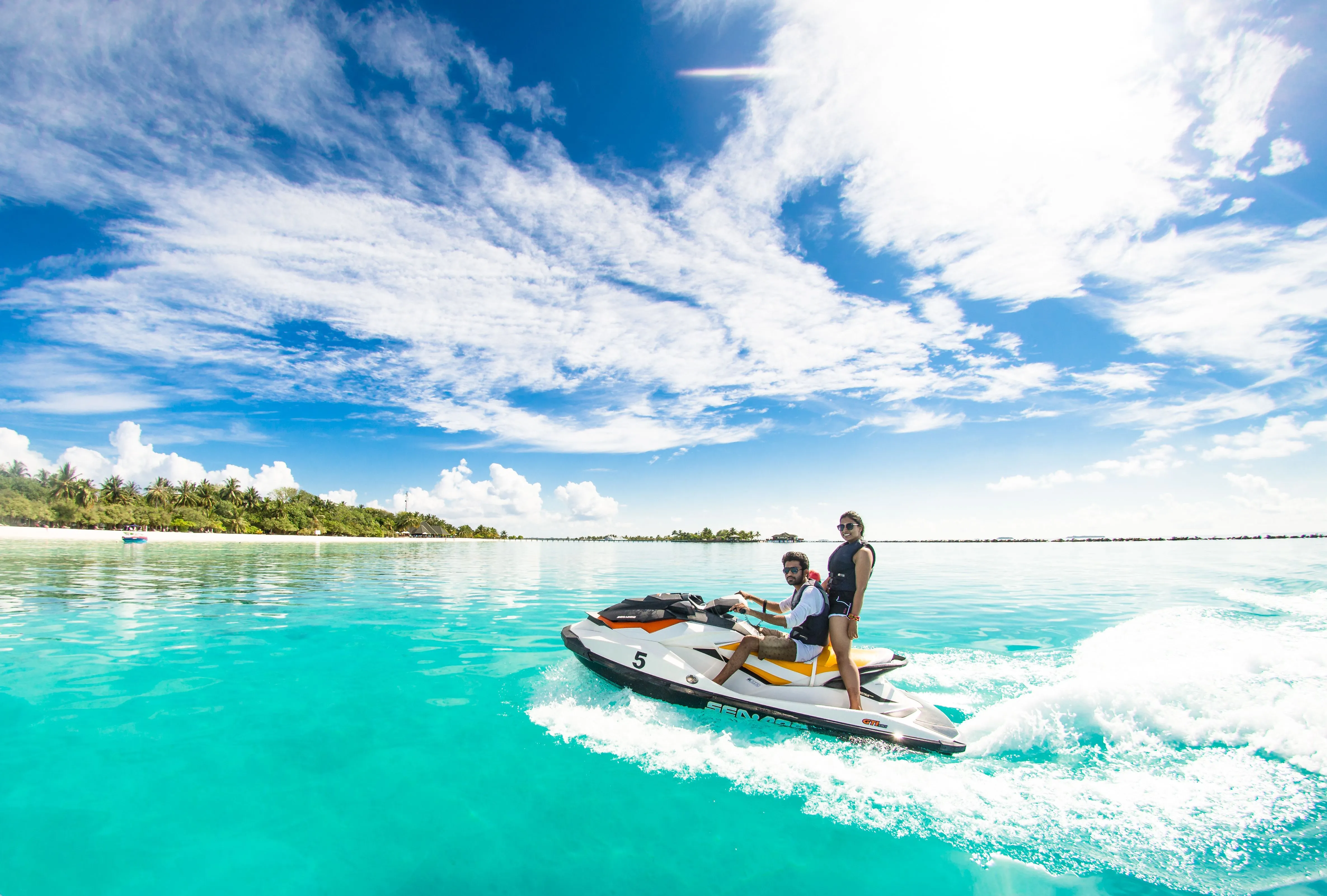 Two People Riding A Jet Ski · Free