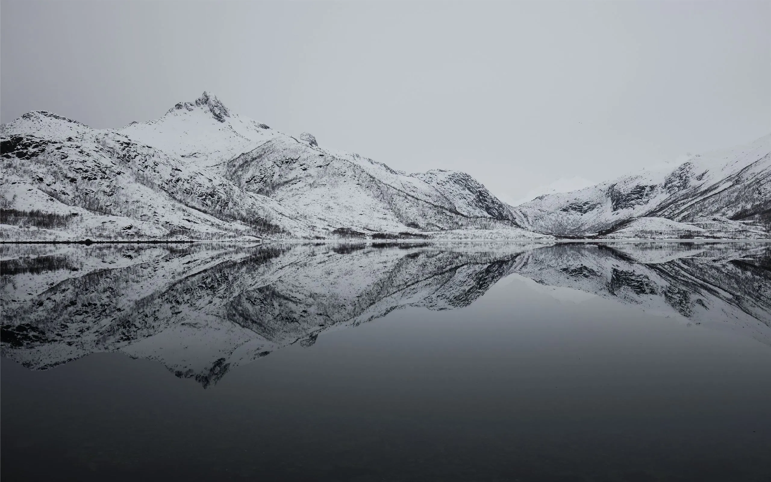 black and white mountain filled with snow near lak MacBook Air Wallpaper Download