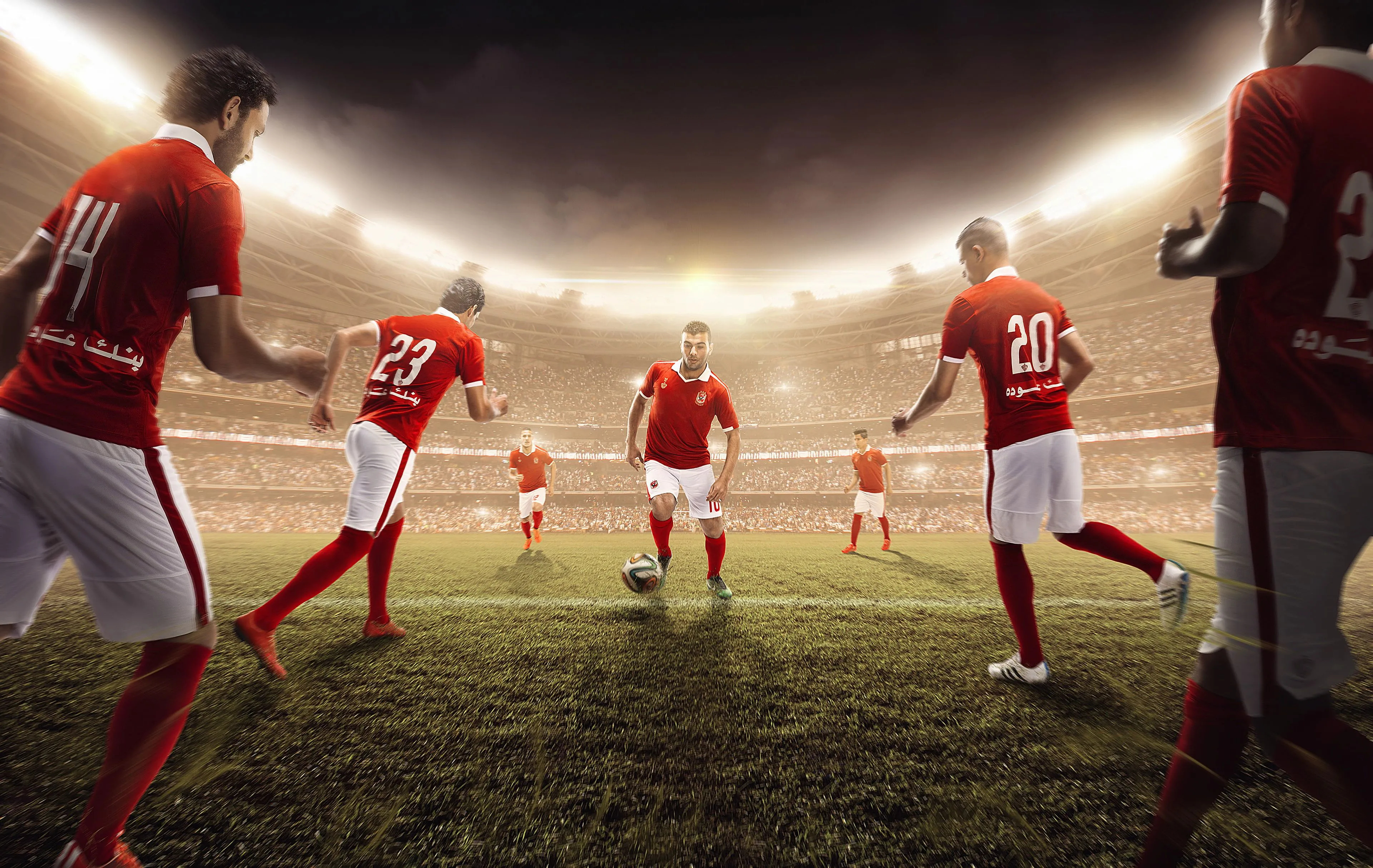 Soccer players in red soccer jersey playing soccer on soccer field HD wallpaper