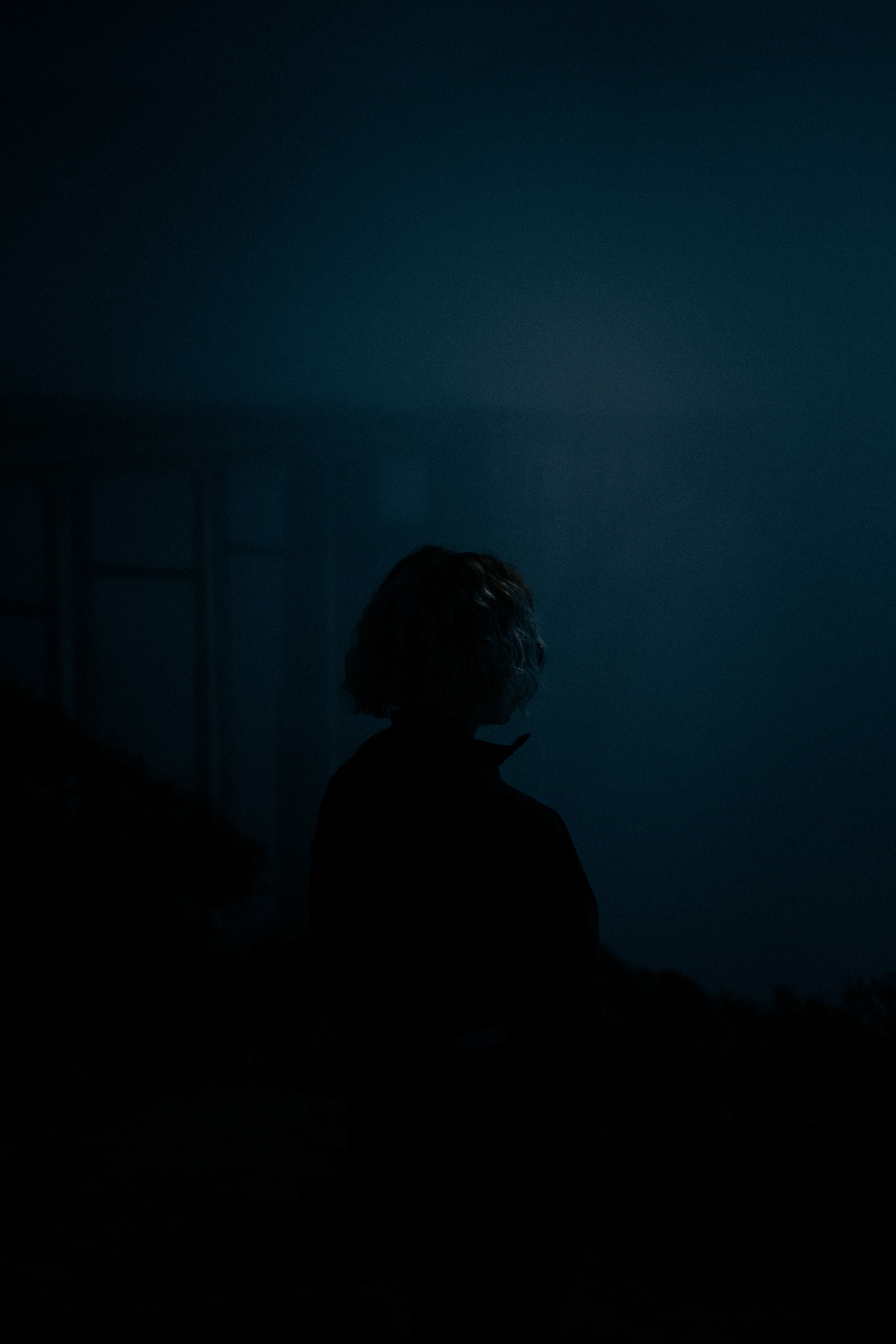 Silhouette of a person in a dark, moody setting. photo