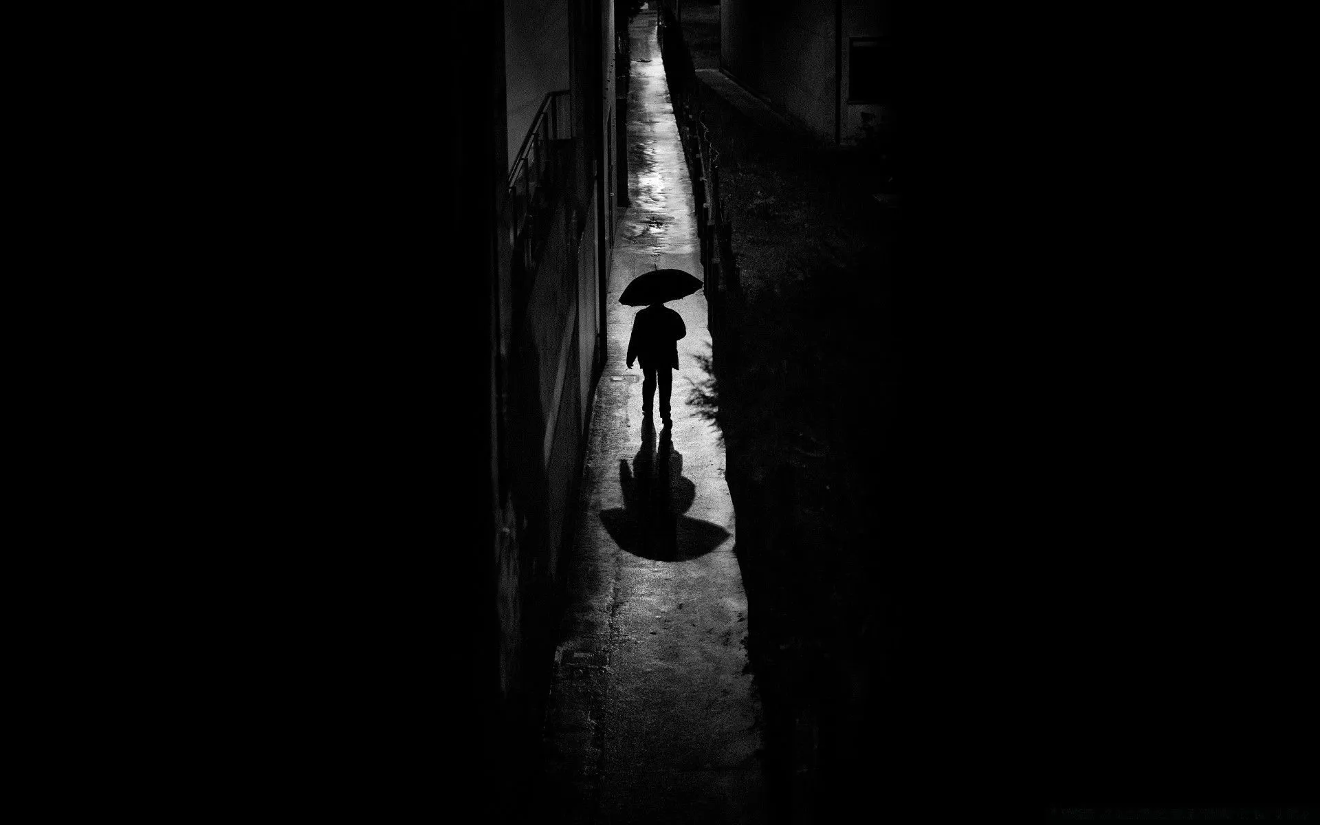 Silhouette Of A Man Under An Umbrella In Black And