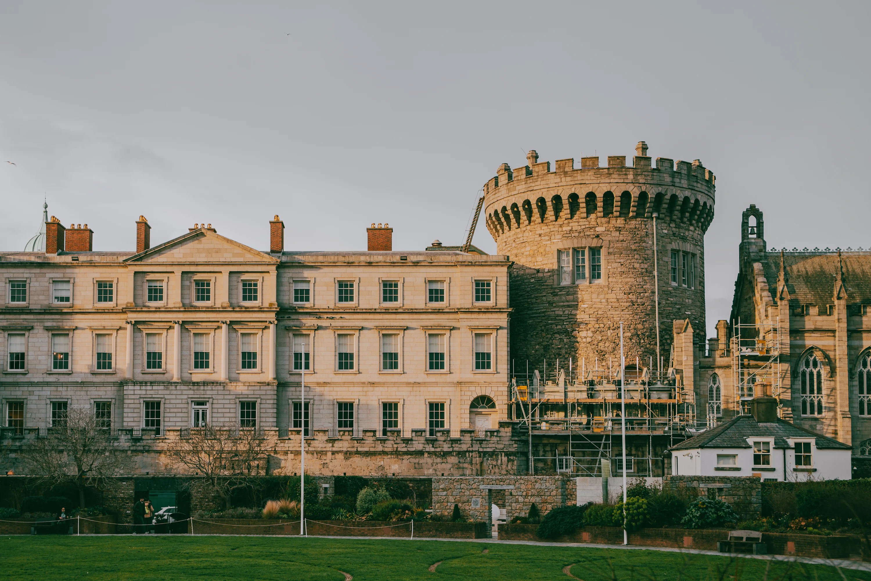 A large castle like building with a green field in front of it photo