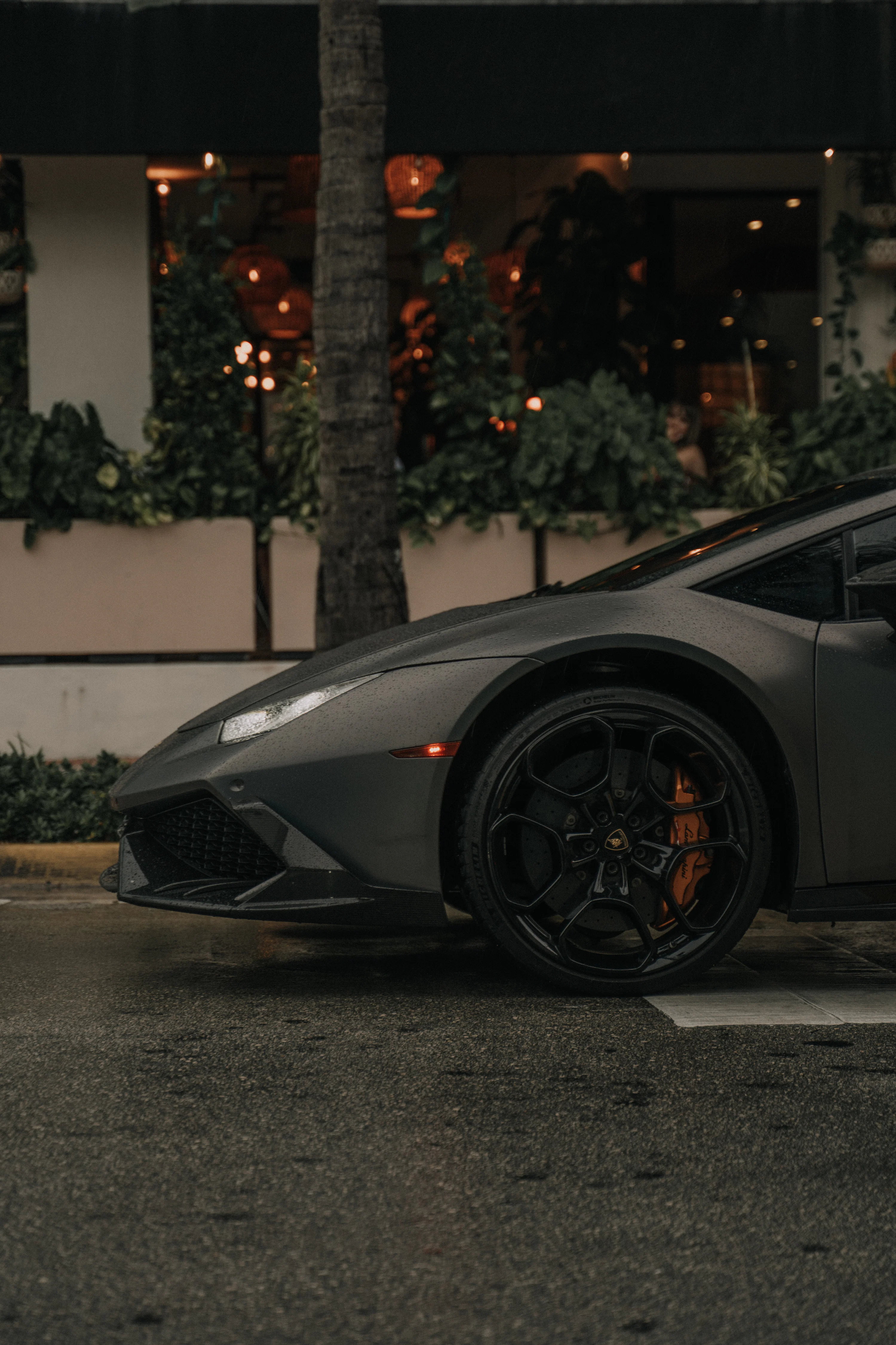 Black lamborghini aventador parked on gray concrete road during daytime photo