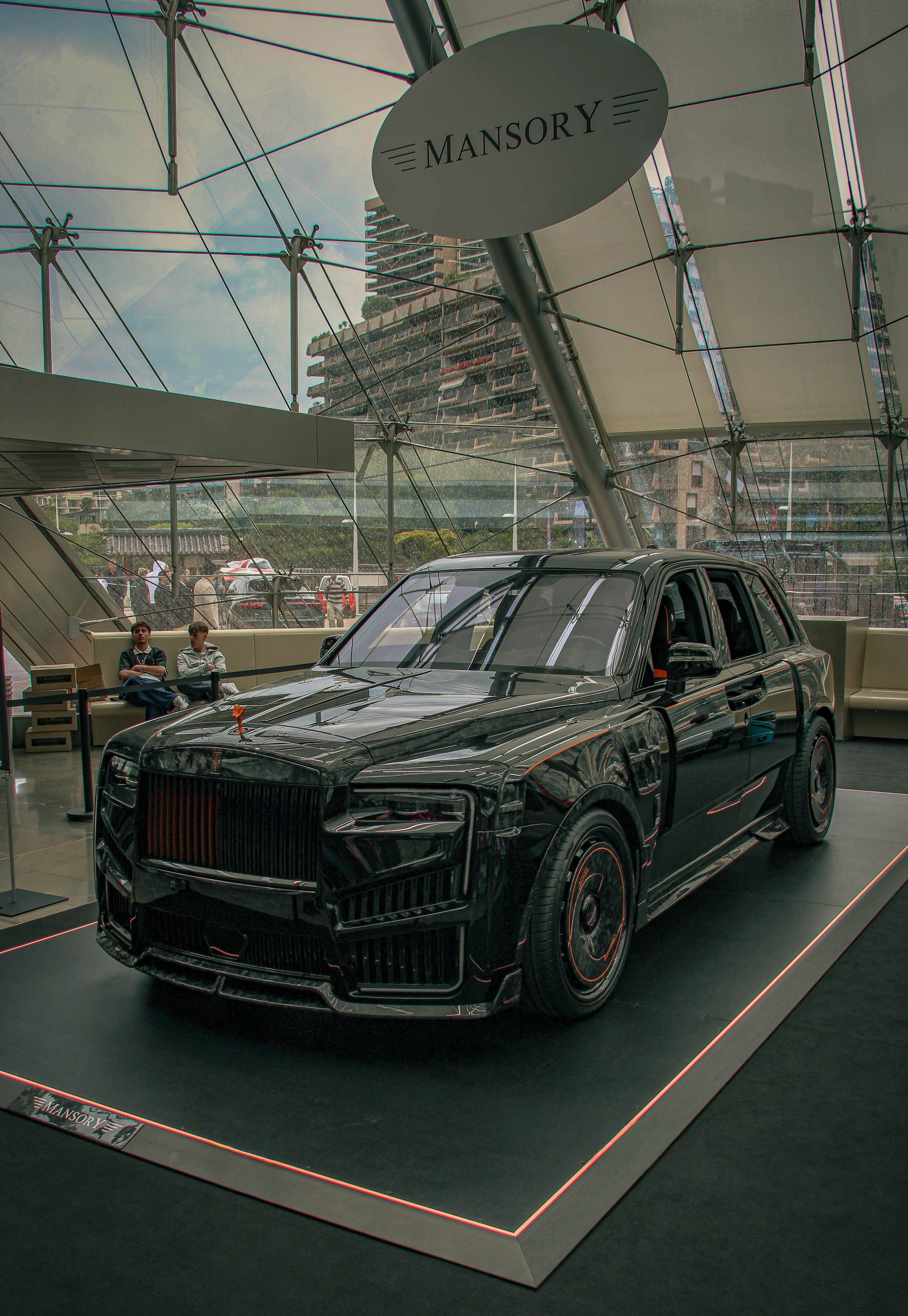 Sleek black luxury suv displayed under a mansory sign