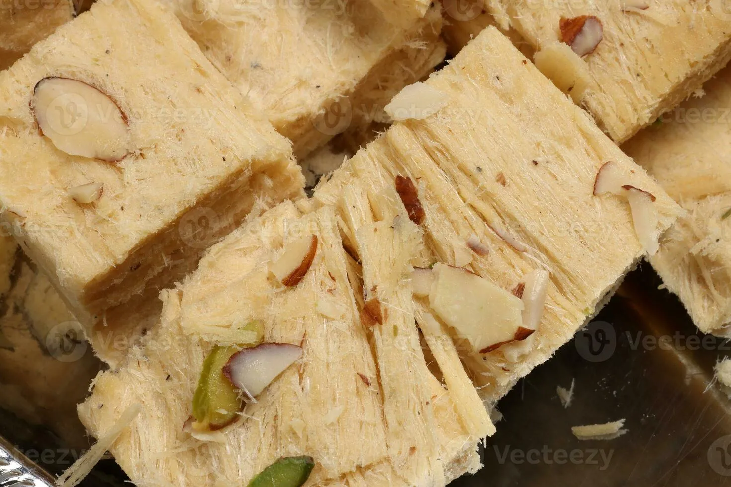 Shompapri Soan papdi cube cut flaky sweet made from flower ghee sugar on silver metal tray plate