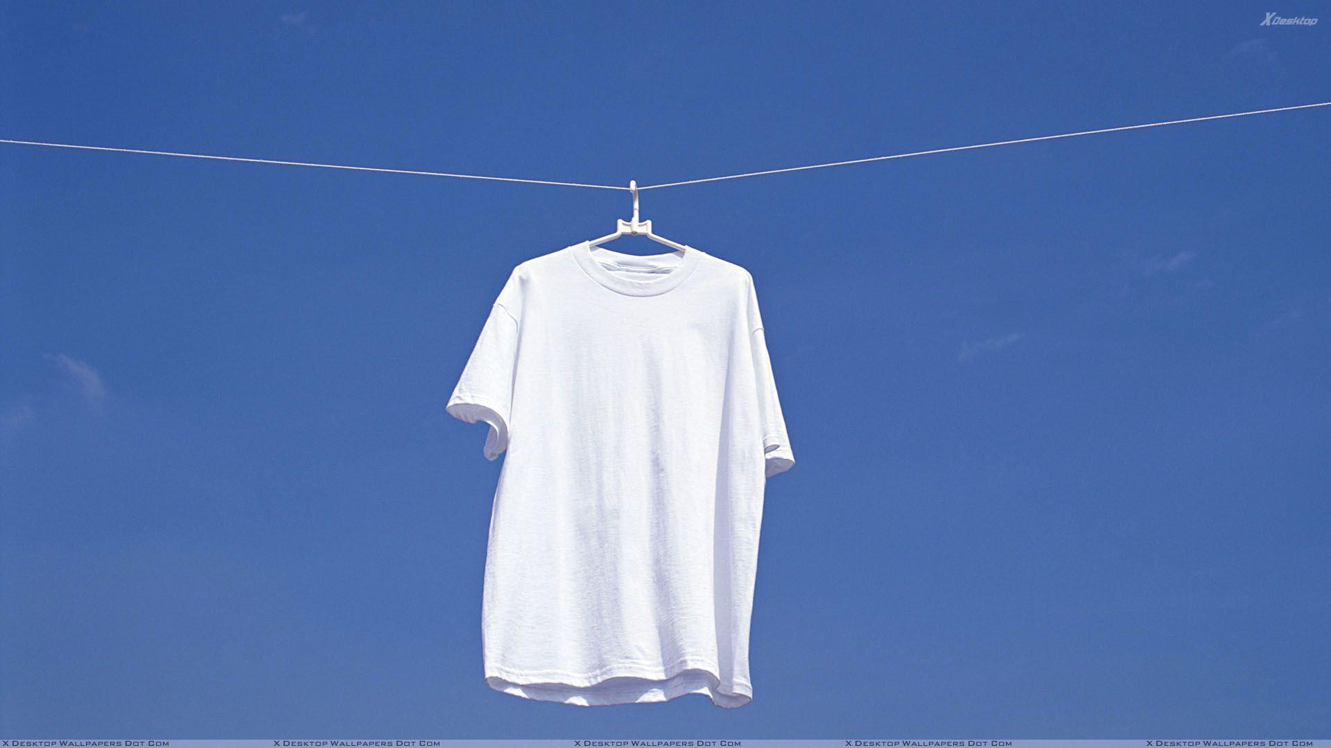 White T Shirt Hanging N Blue Background Wallpaper