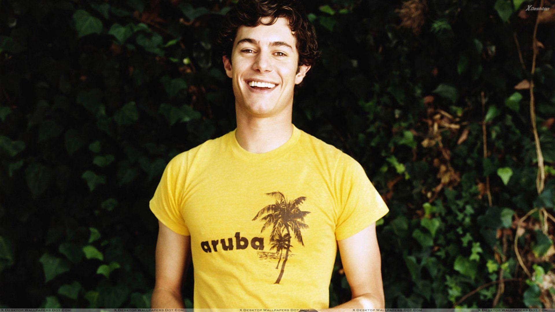 Adam Brody Laughing In Yellow T Shirt Wallpaper