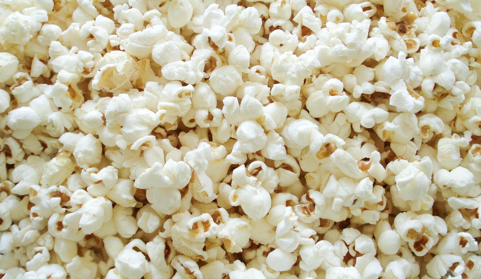 Cinema seamless pattern wallpaper with popcorn Vector Image