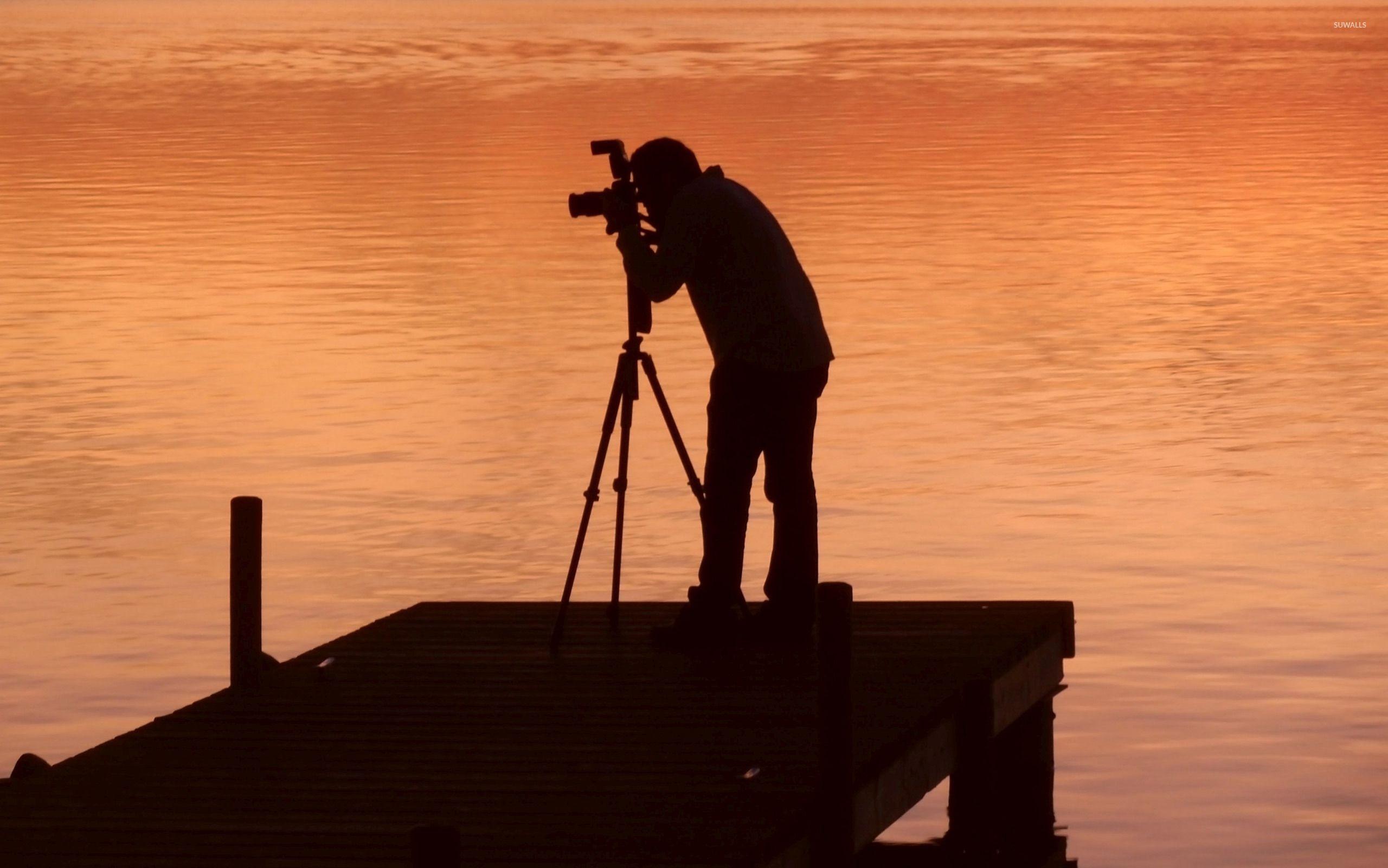 Photographer capturing the sunset wallpaper