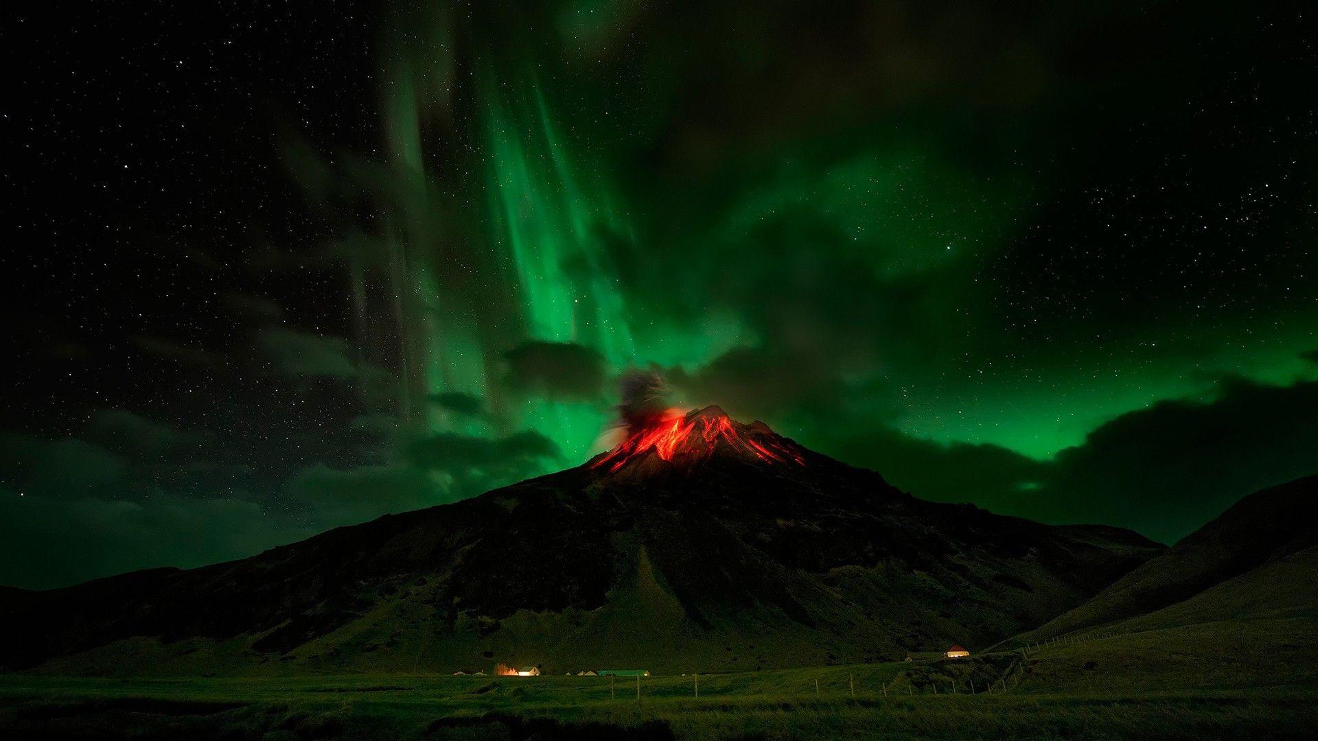 Northern Lights over a flaming volcano wallpaper and image