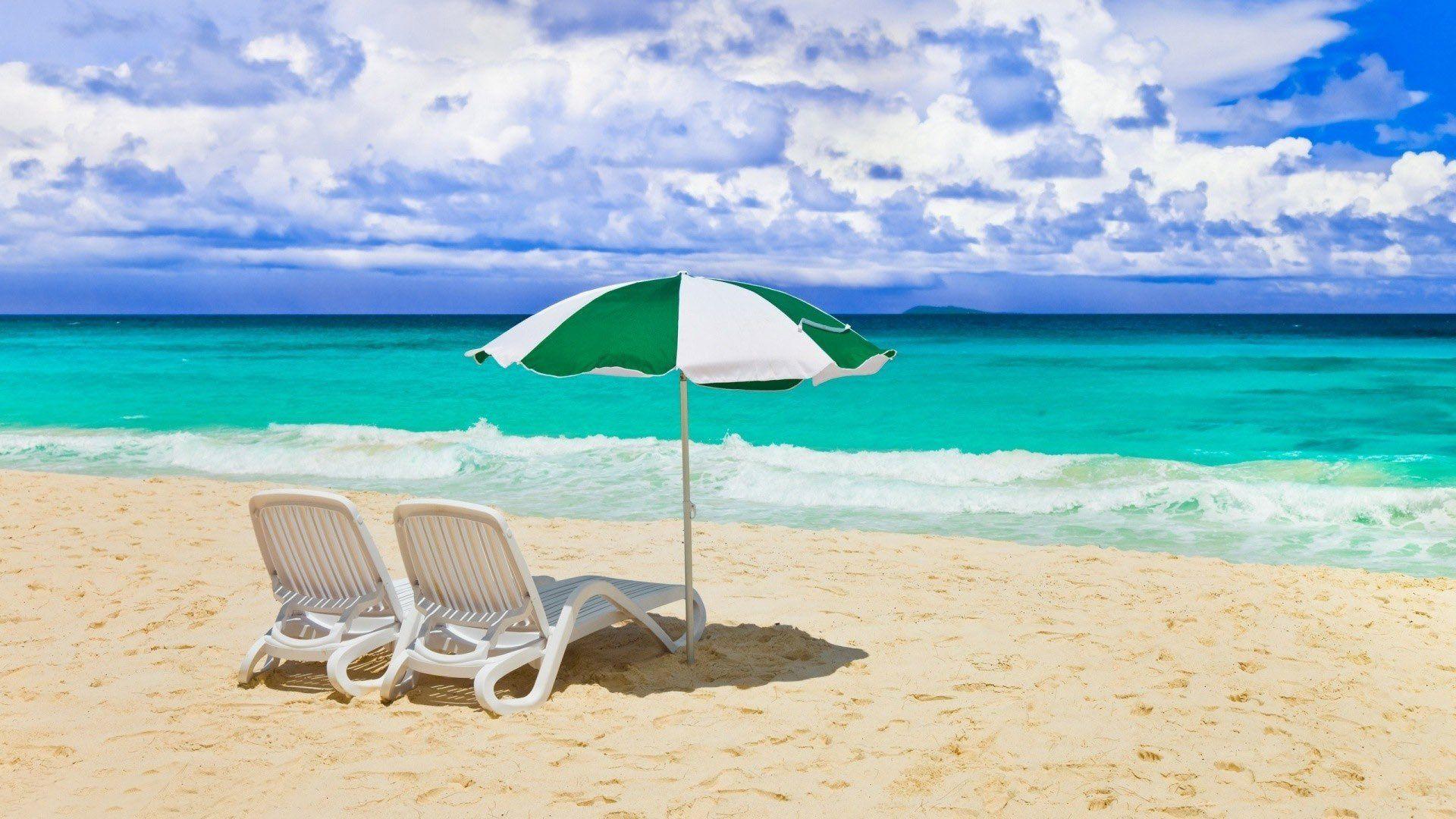 Chairs And Umbrella On The Beach Wallpaper