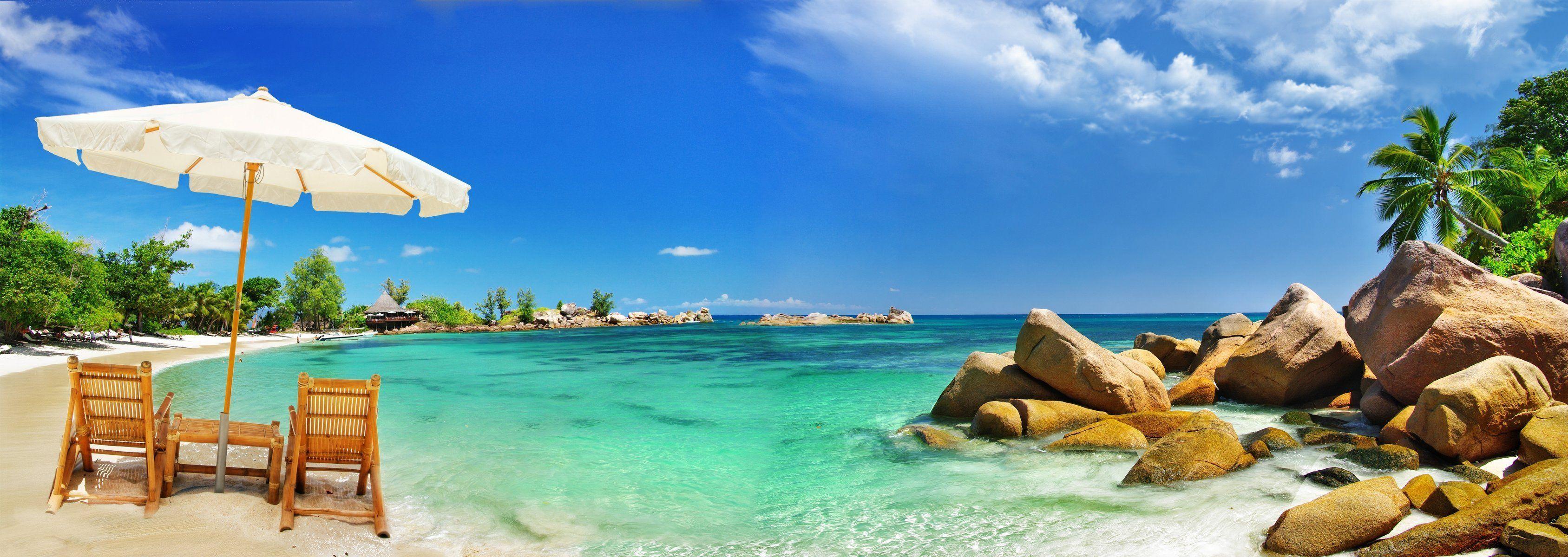 coast sea beach sand stones palm tropics umbrella chairs coast