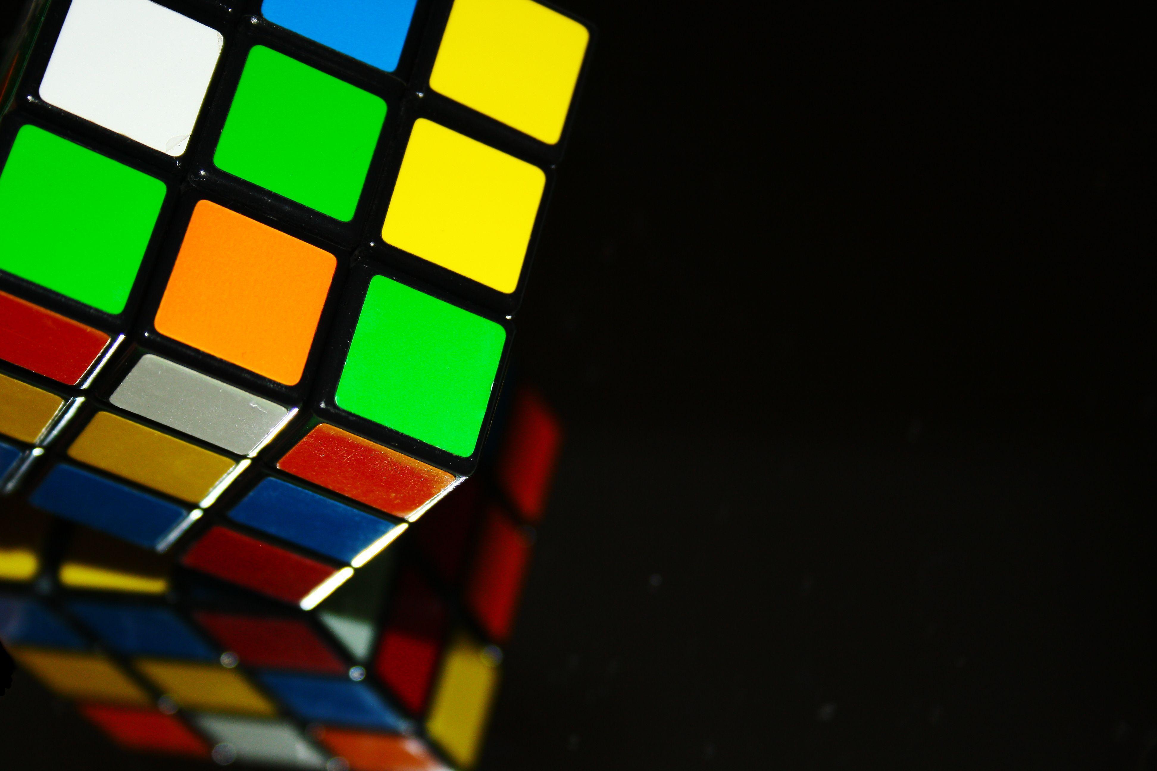 Immerse Yourself in the Mesmerizing Melting Artwork of a Rubiks Cube with  our OLED Wallpaper for Your Phone