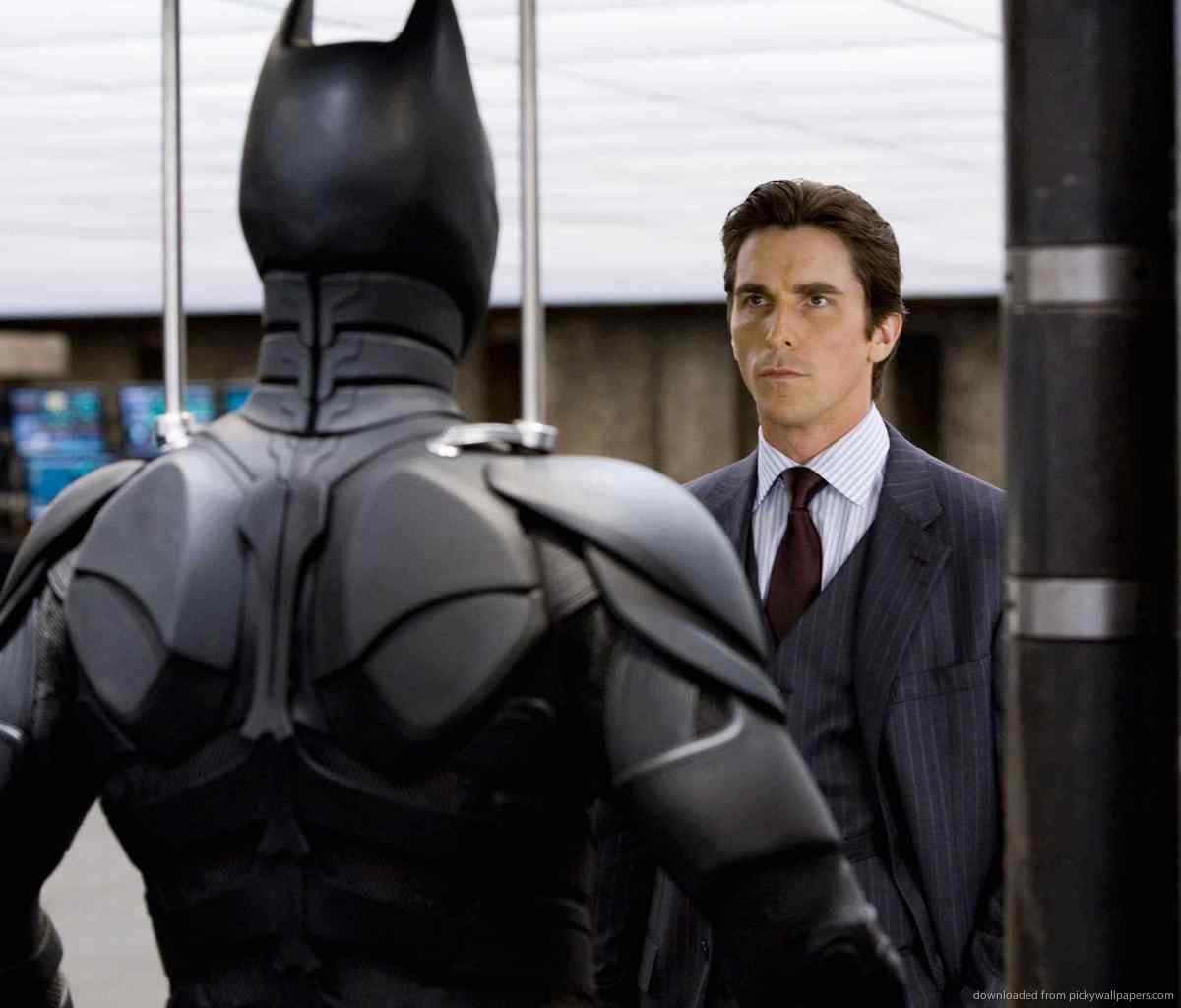 Download Bruce Wayne Looking At Batman Costume Wallpaper