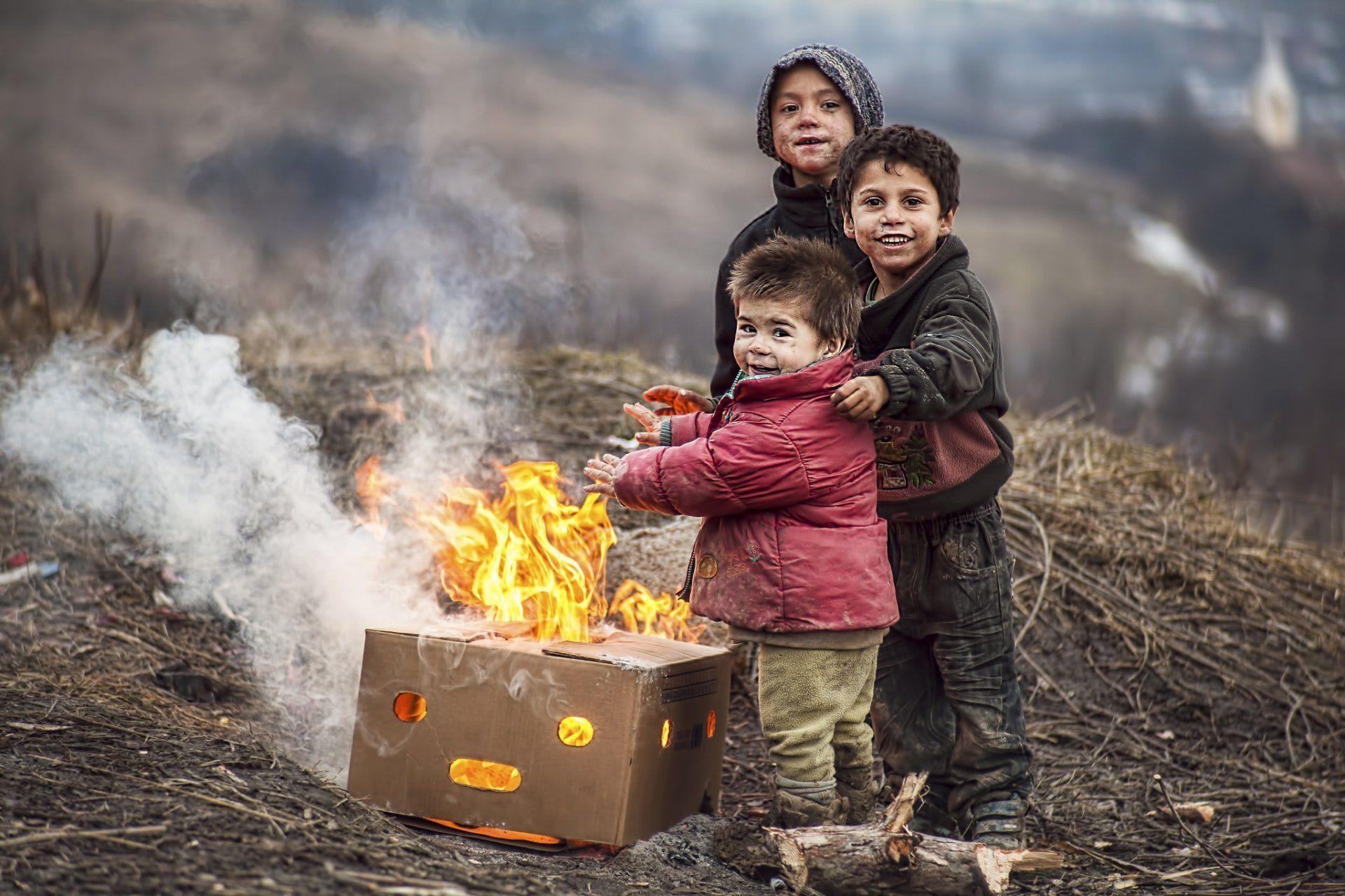 children fire poverty boys grubby smile happiness heat are heated