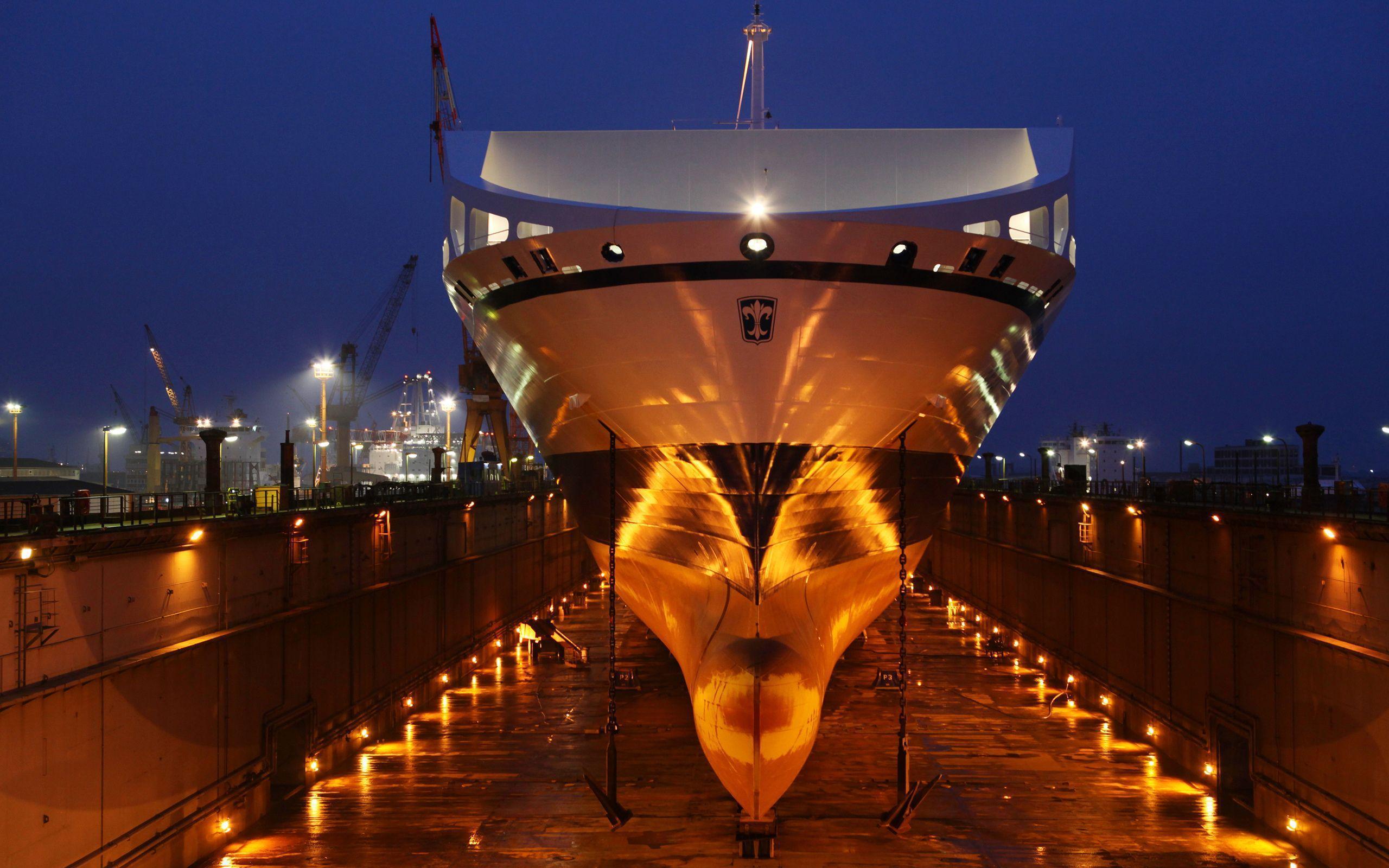 Bore sea port night ship vessel anchores dock lights dry dock