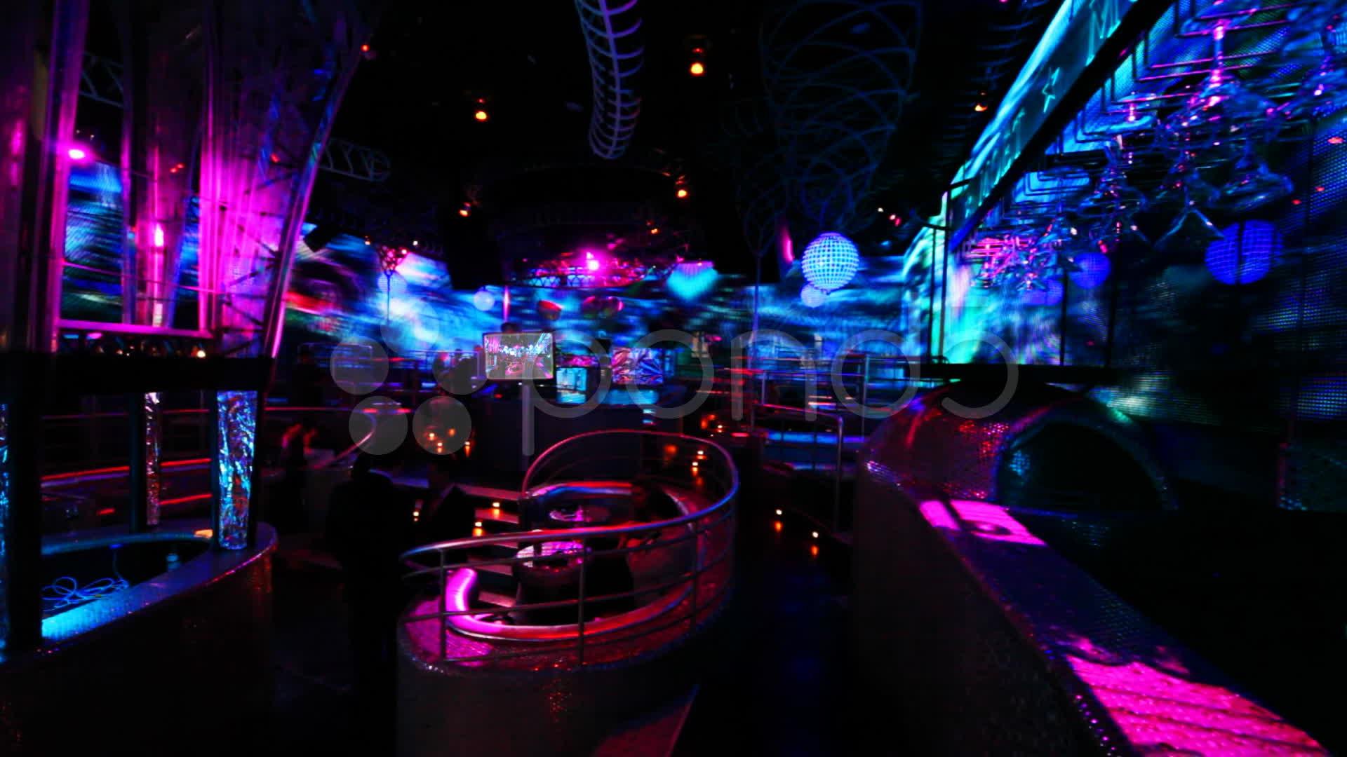 People in nightclub with bright LED illumination on walls Video