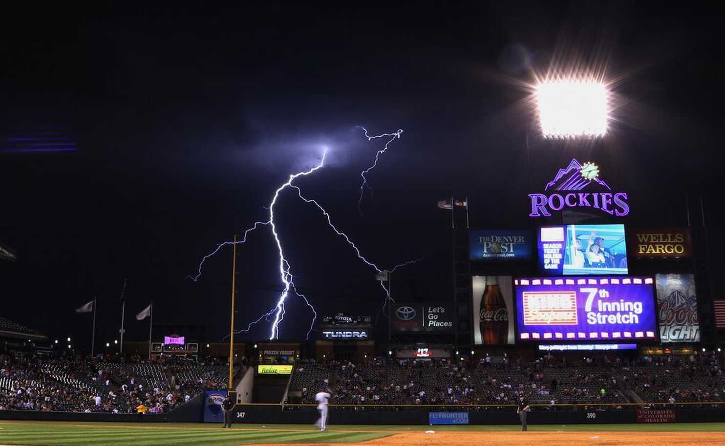 Stormy skies fill big baseball venues: Rockies, Reds, and Red Sox